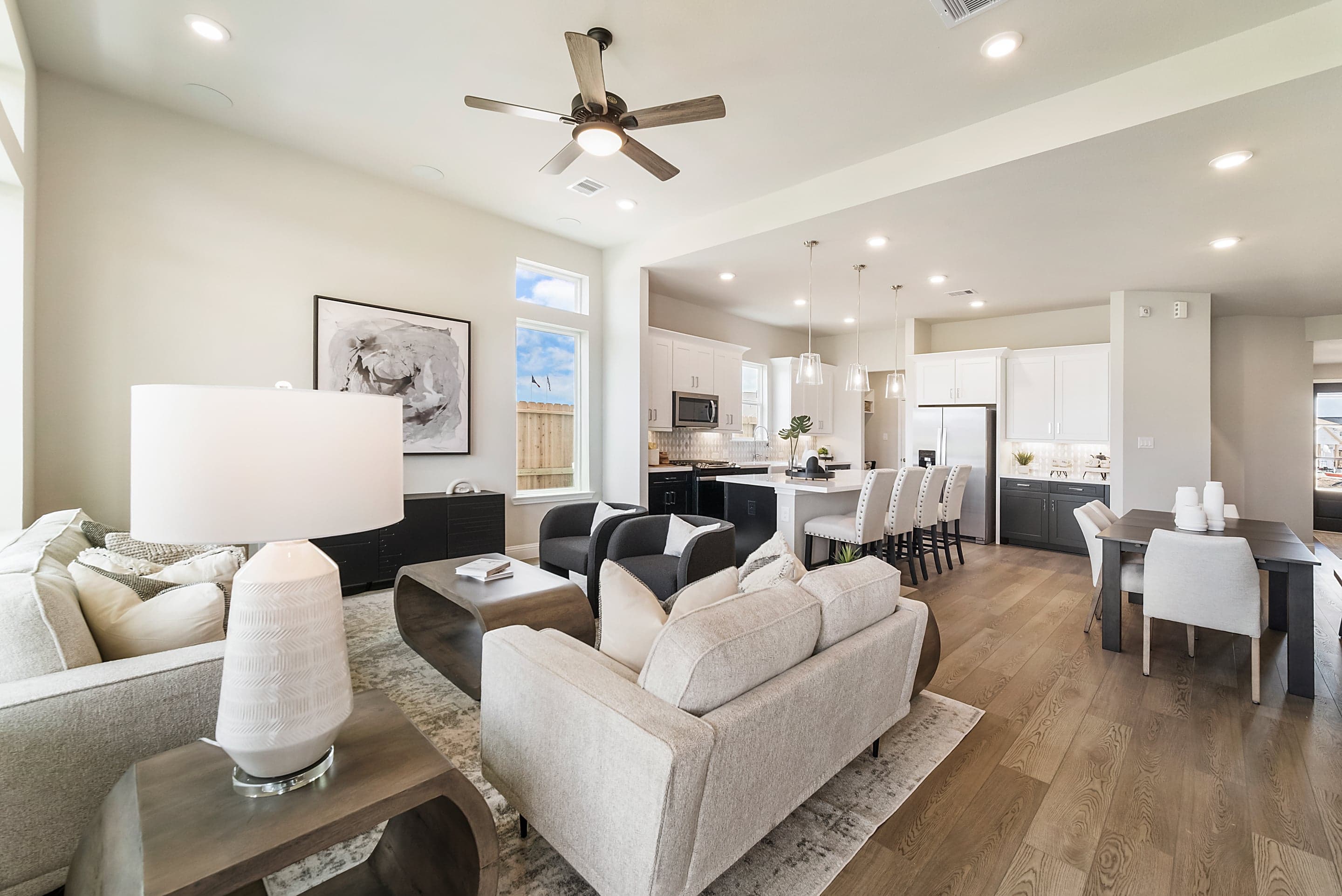 view of great room, dining area, and kitchen with hardwood flooring
