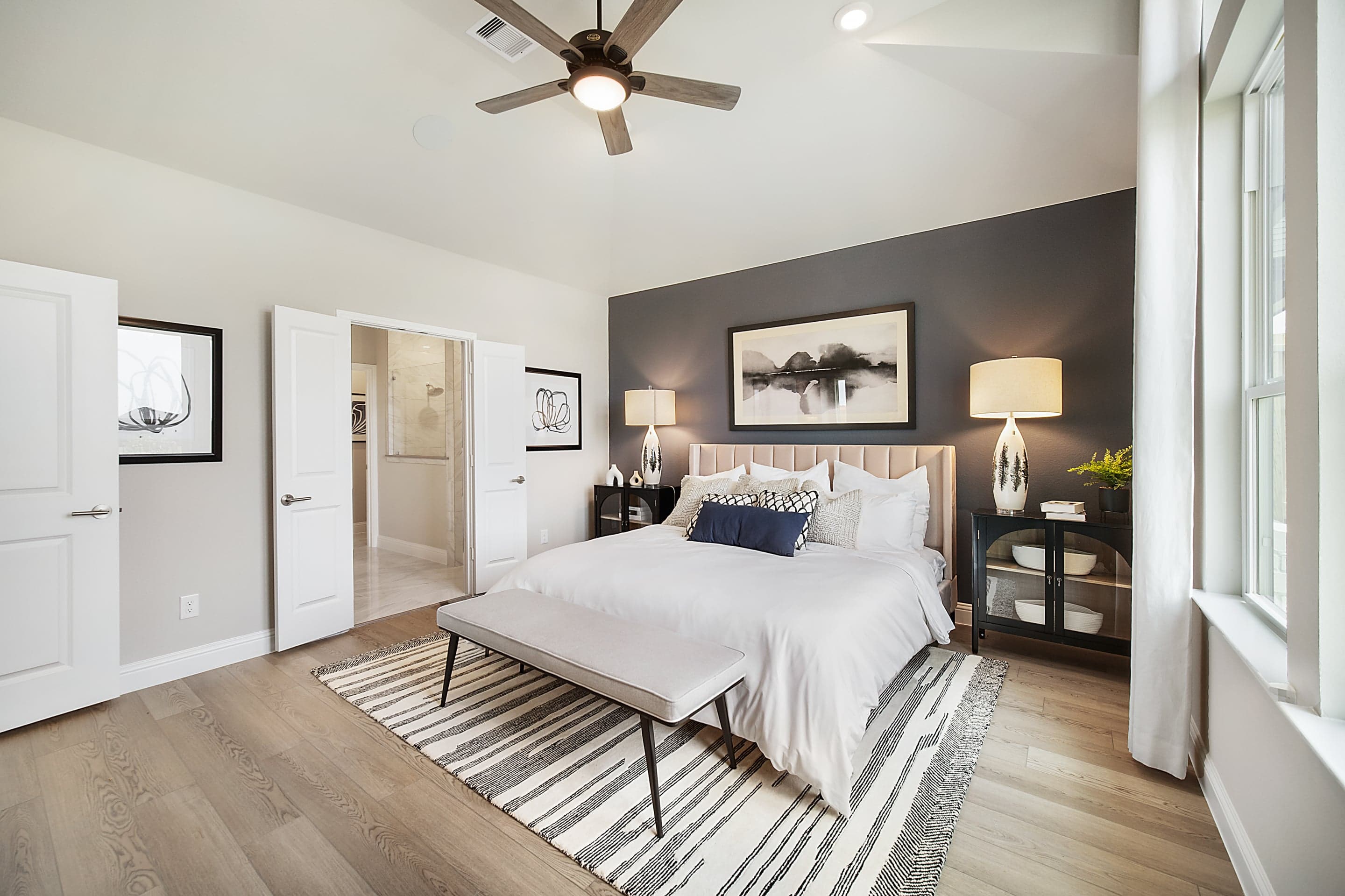 large primary bedroom with accent wall