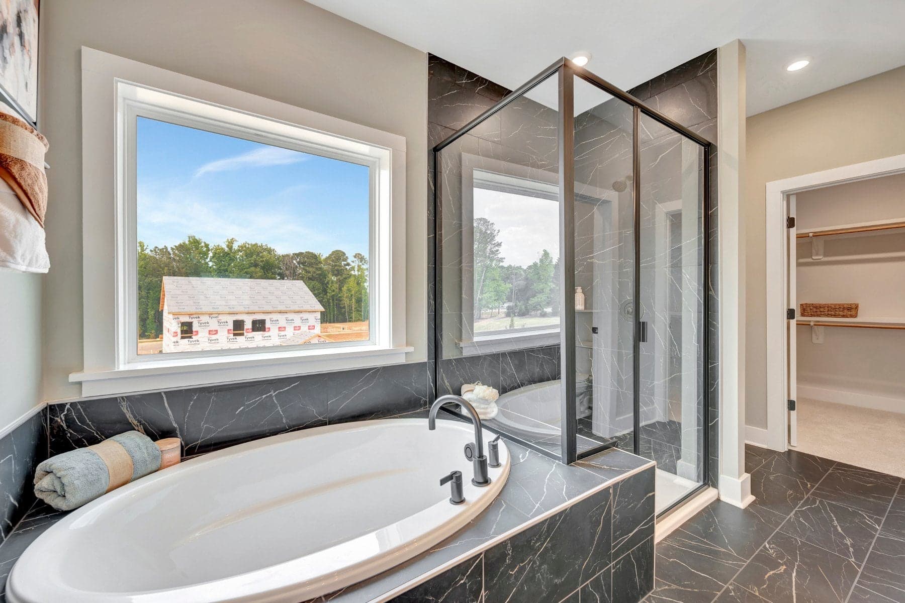 primary bath with a separate tub and shower