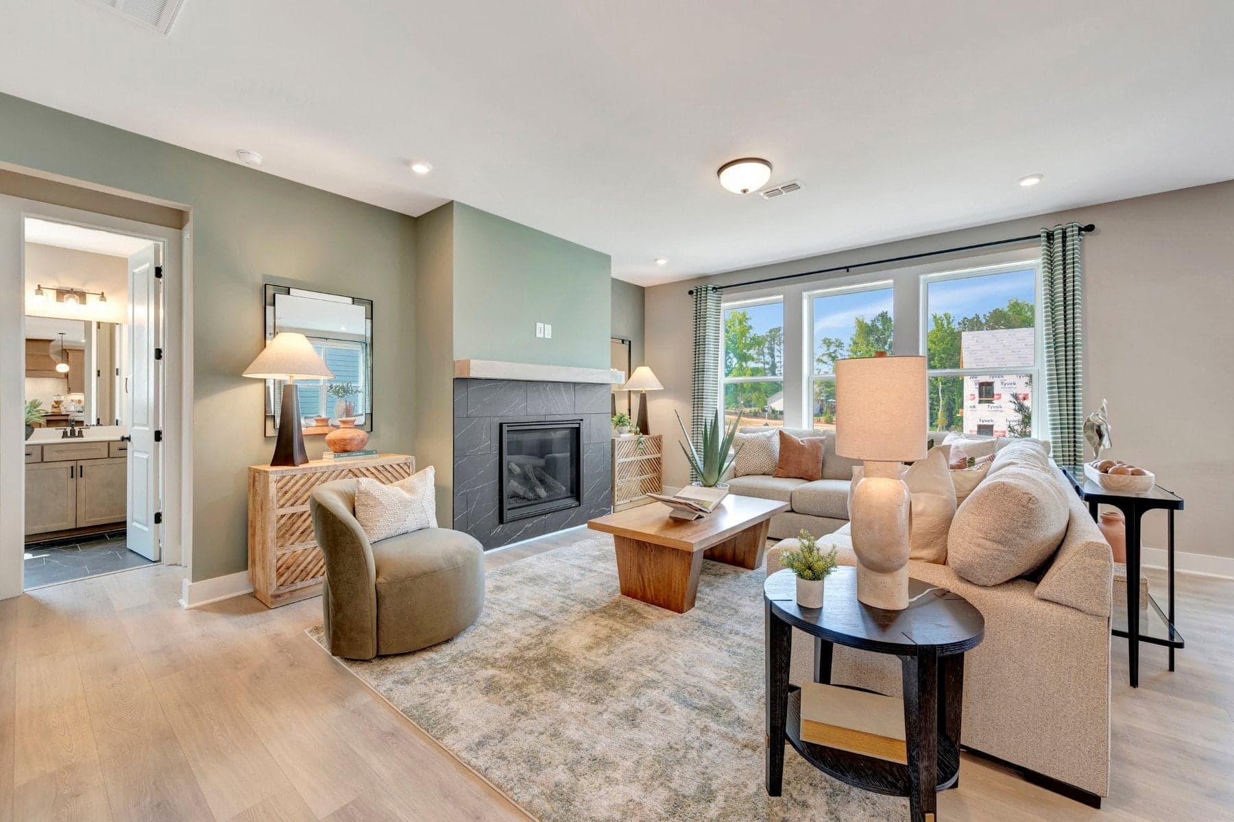 great room with three windows and a fireplace