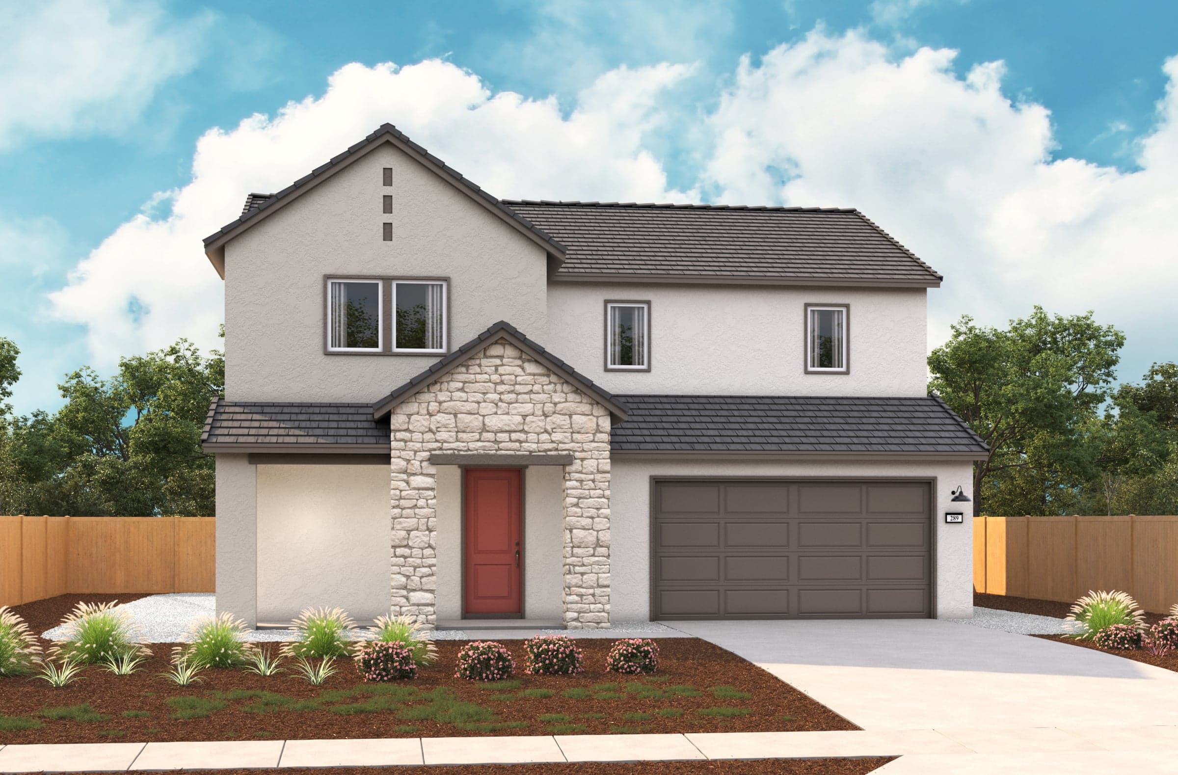 front exterior of two-story tan home with stacked stone entry and red door