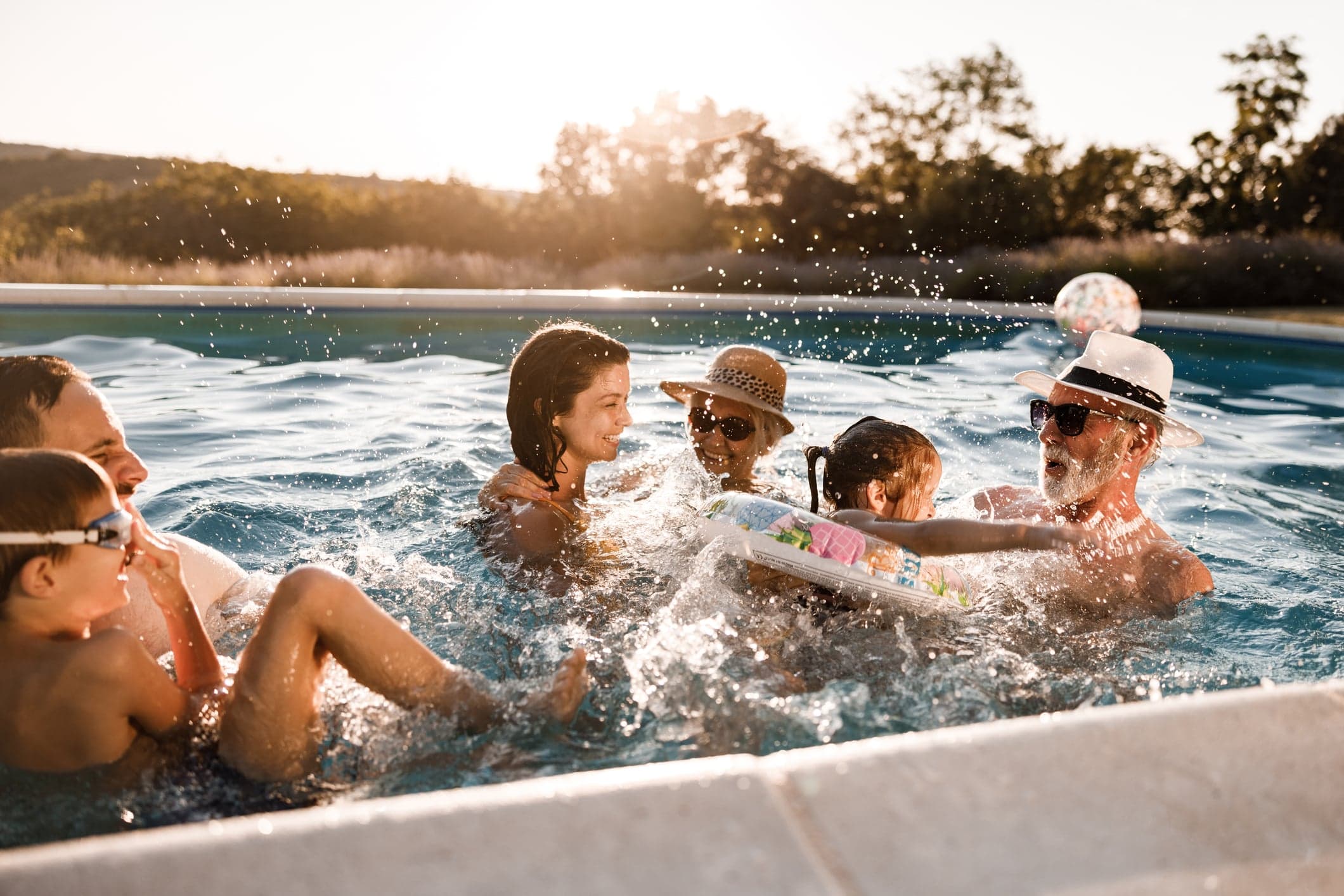 family playing in the pool and splashing around