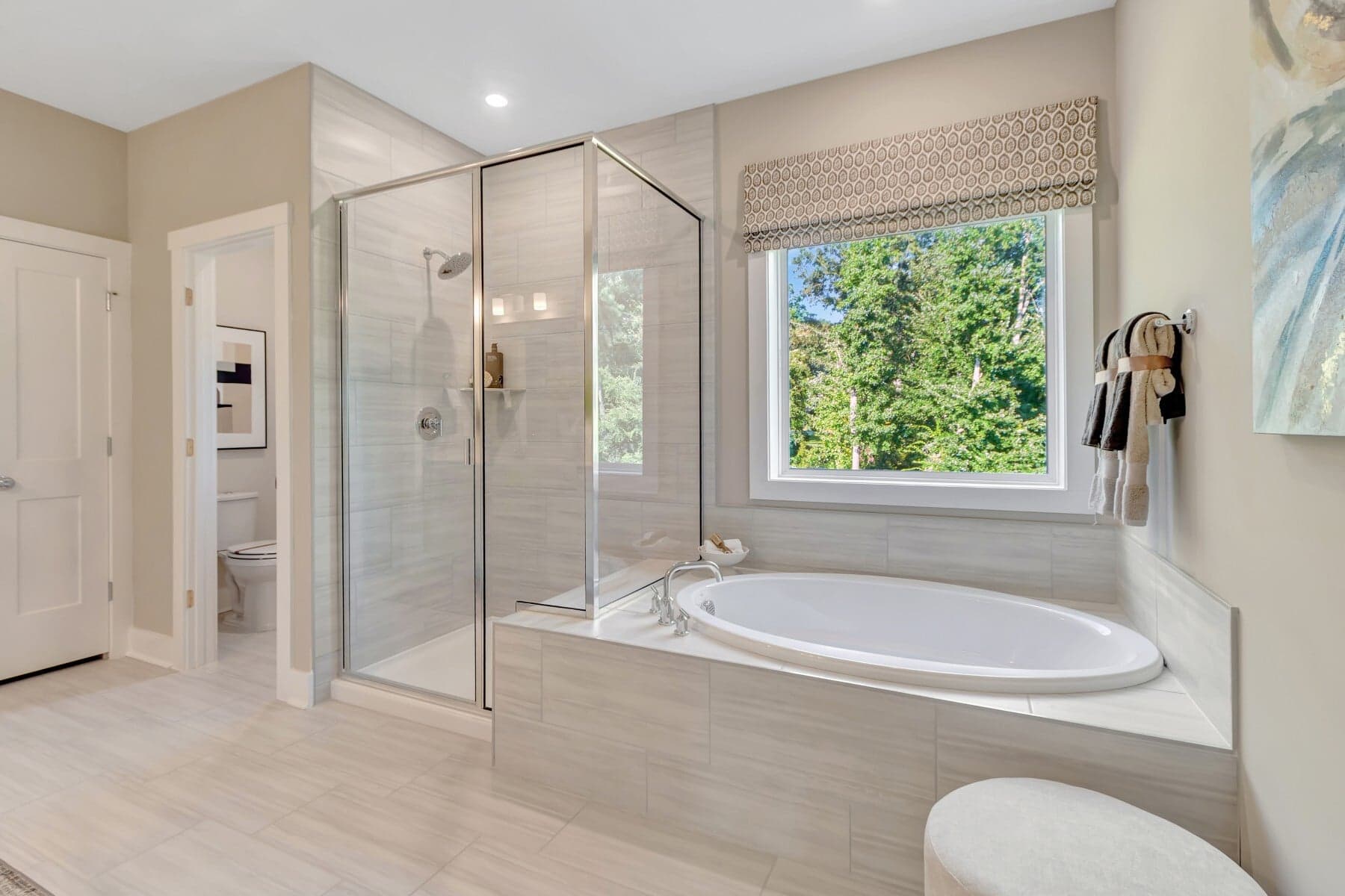 primary bath with a separate tub and shower