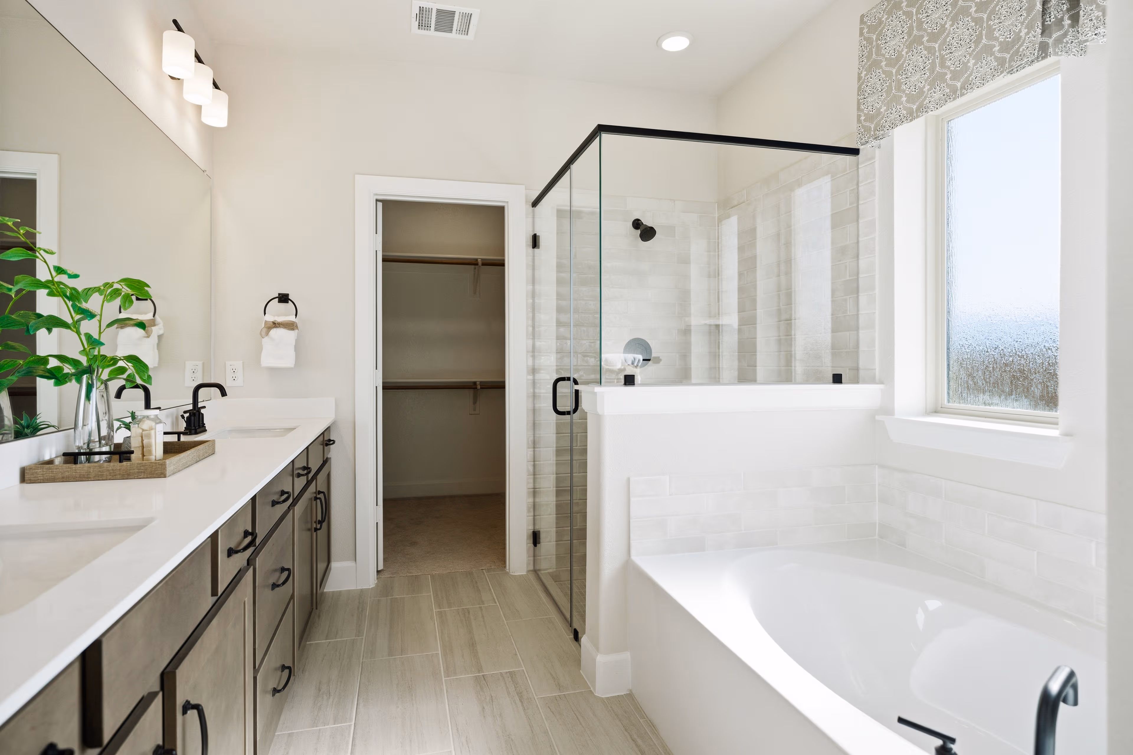 primary bathroom with separate soaking tub and shower