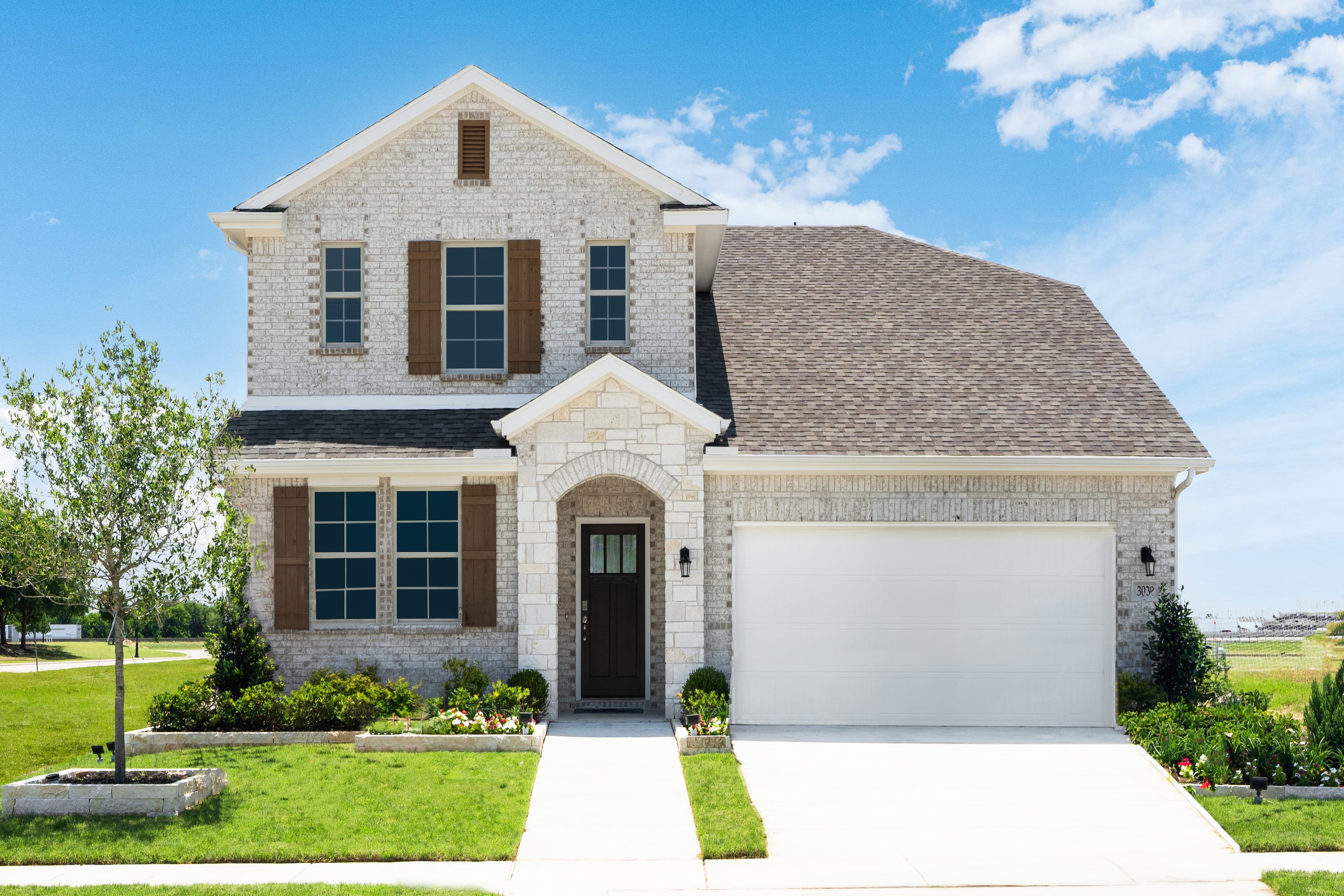 two-story home with a brick and stone exterior