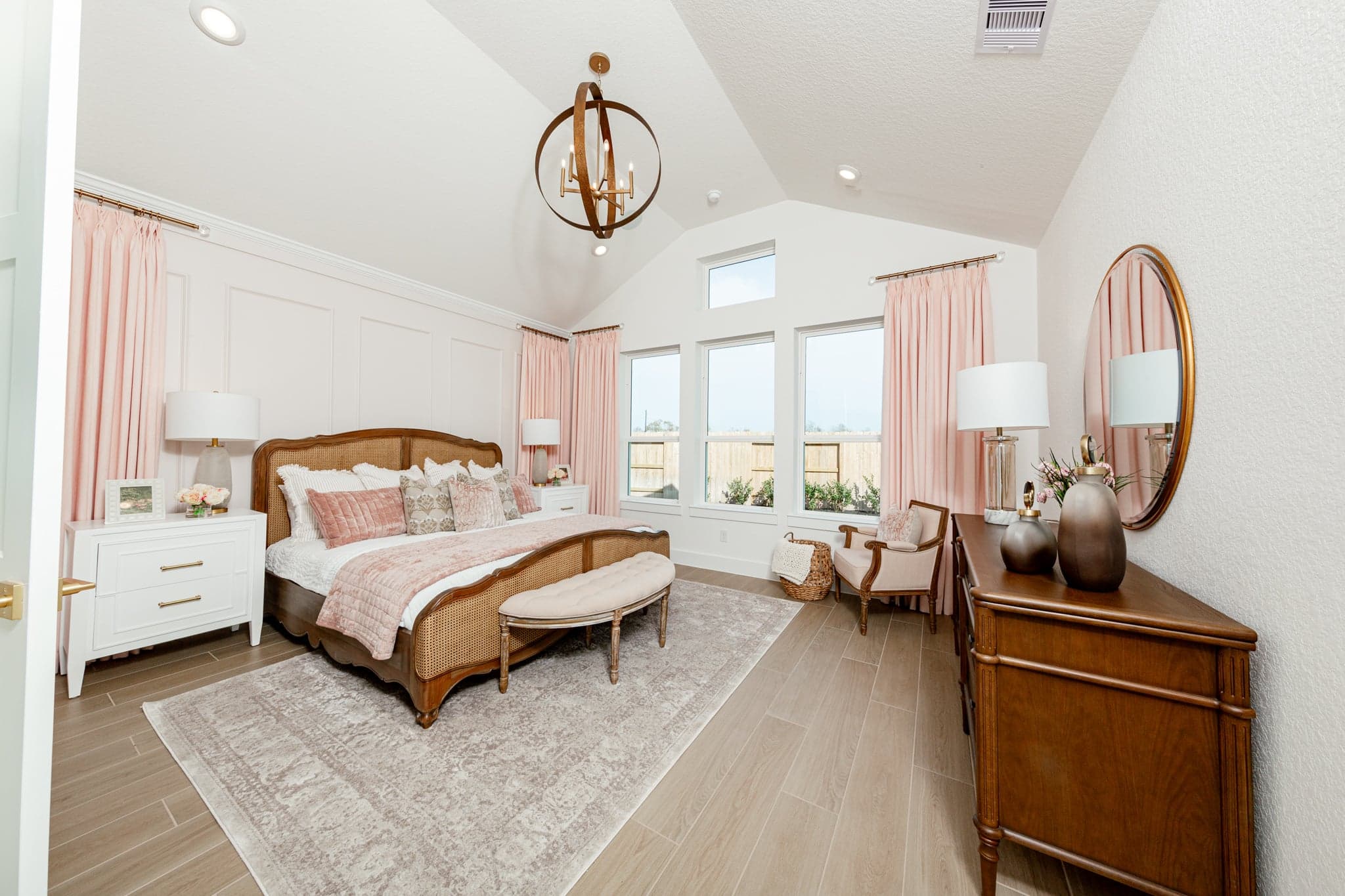 spacious primary bedroom with carpet and windows