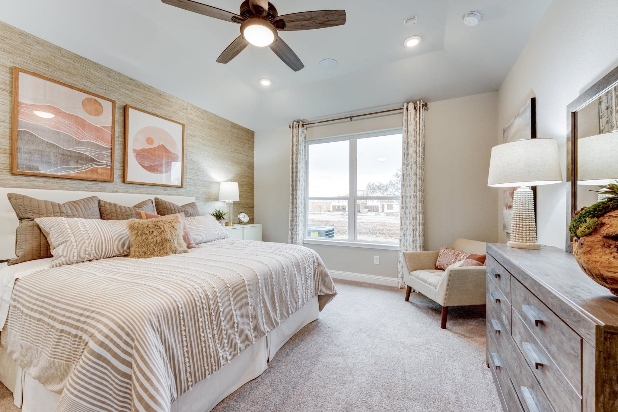 primary bedroom with accent wall and carpet