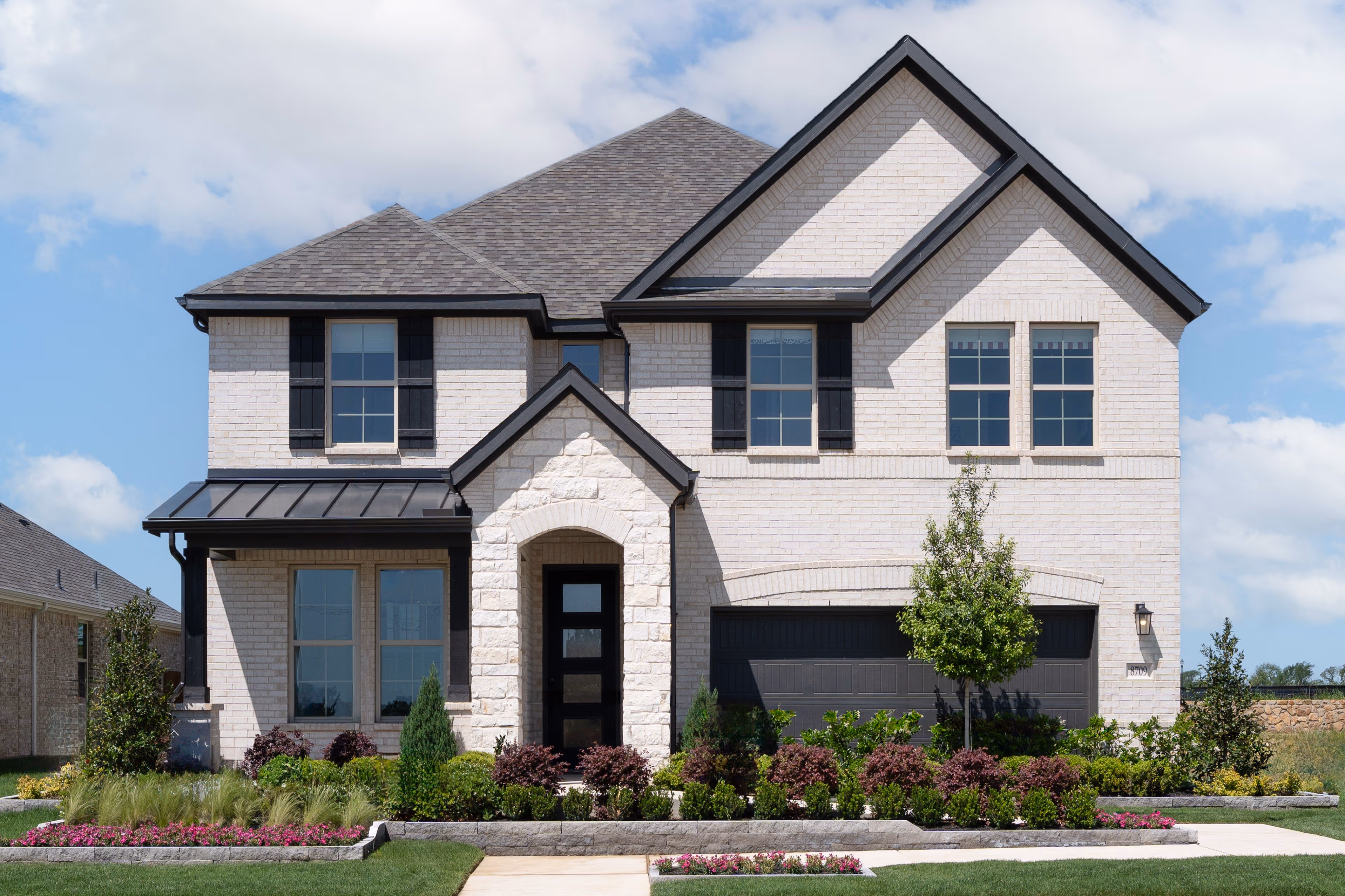 exterior of home with white stone and brick