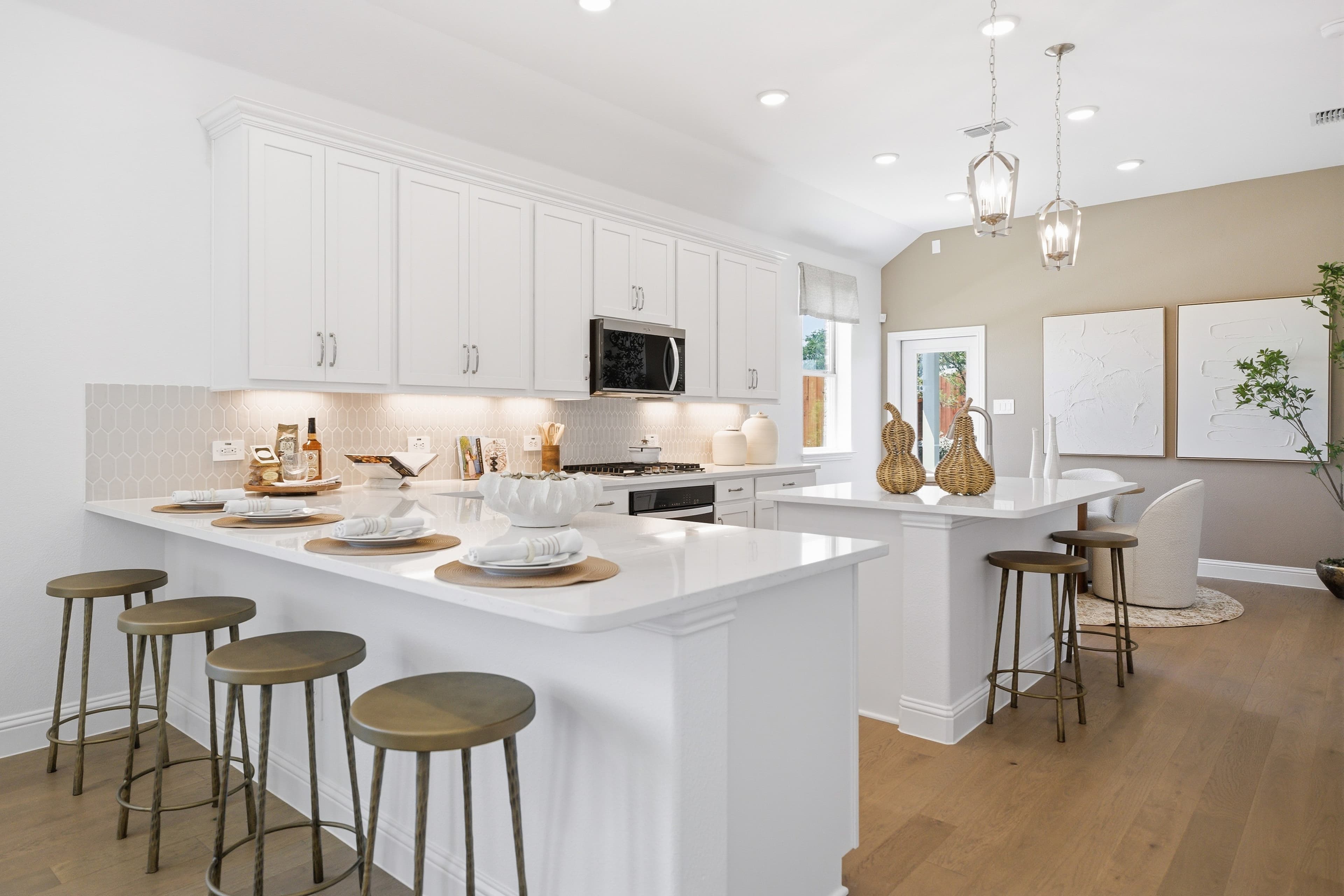 open kitchen with white cabinets and hardwood flooring