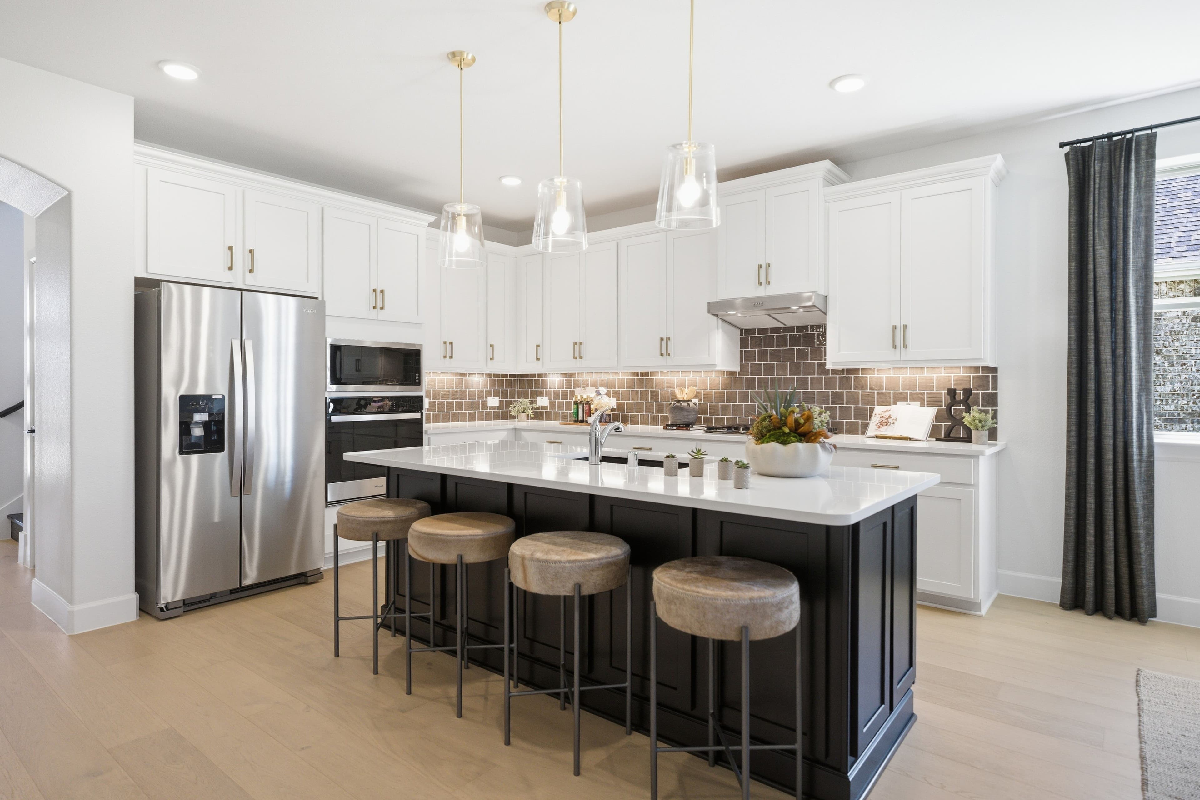 open kitchen with white cabinets and hardwood flooring