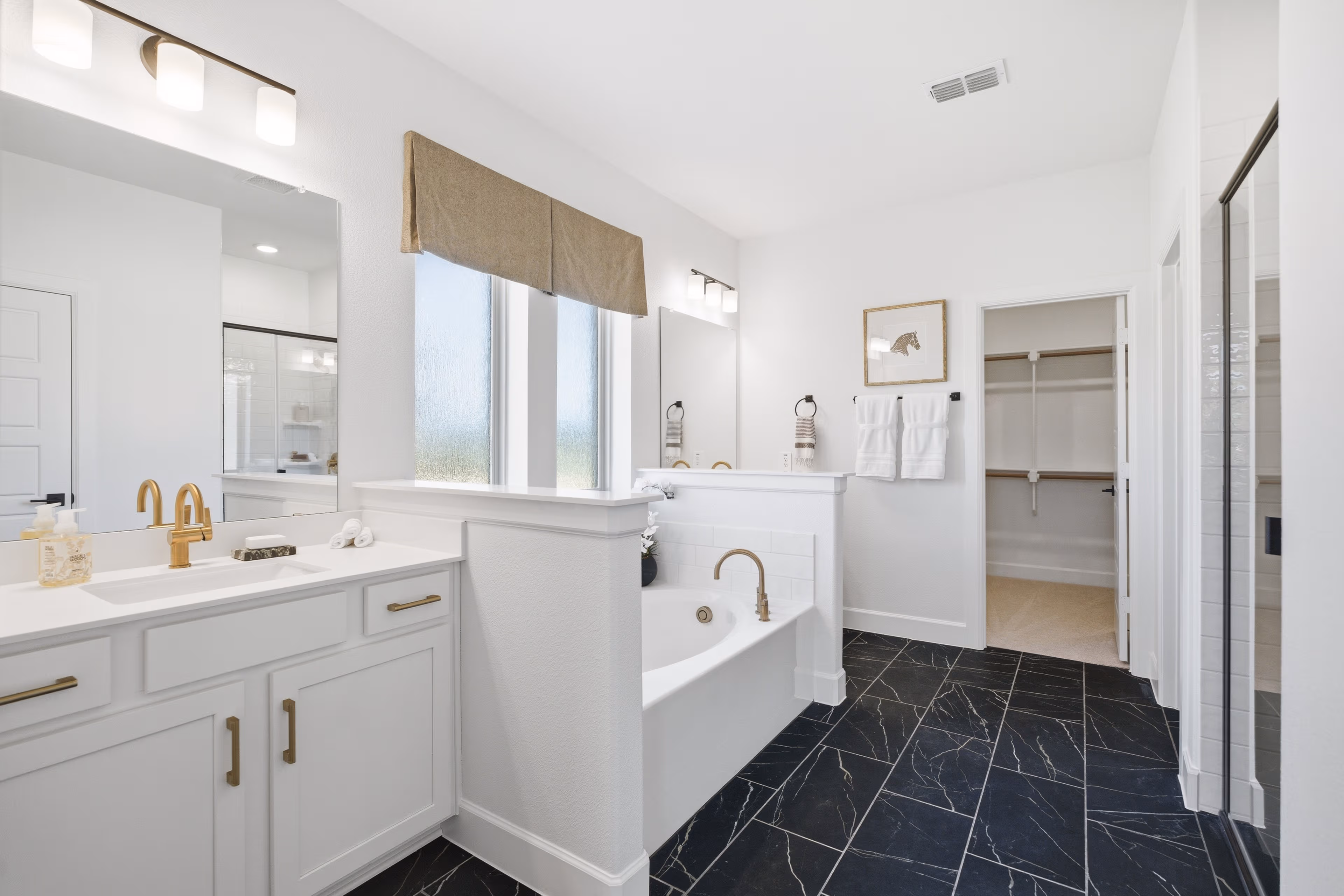 primary bathroom with soaking tub and double sinks