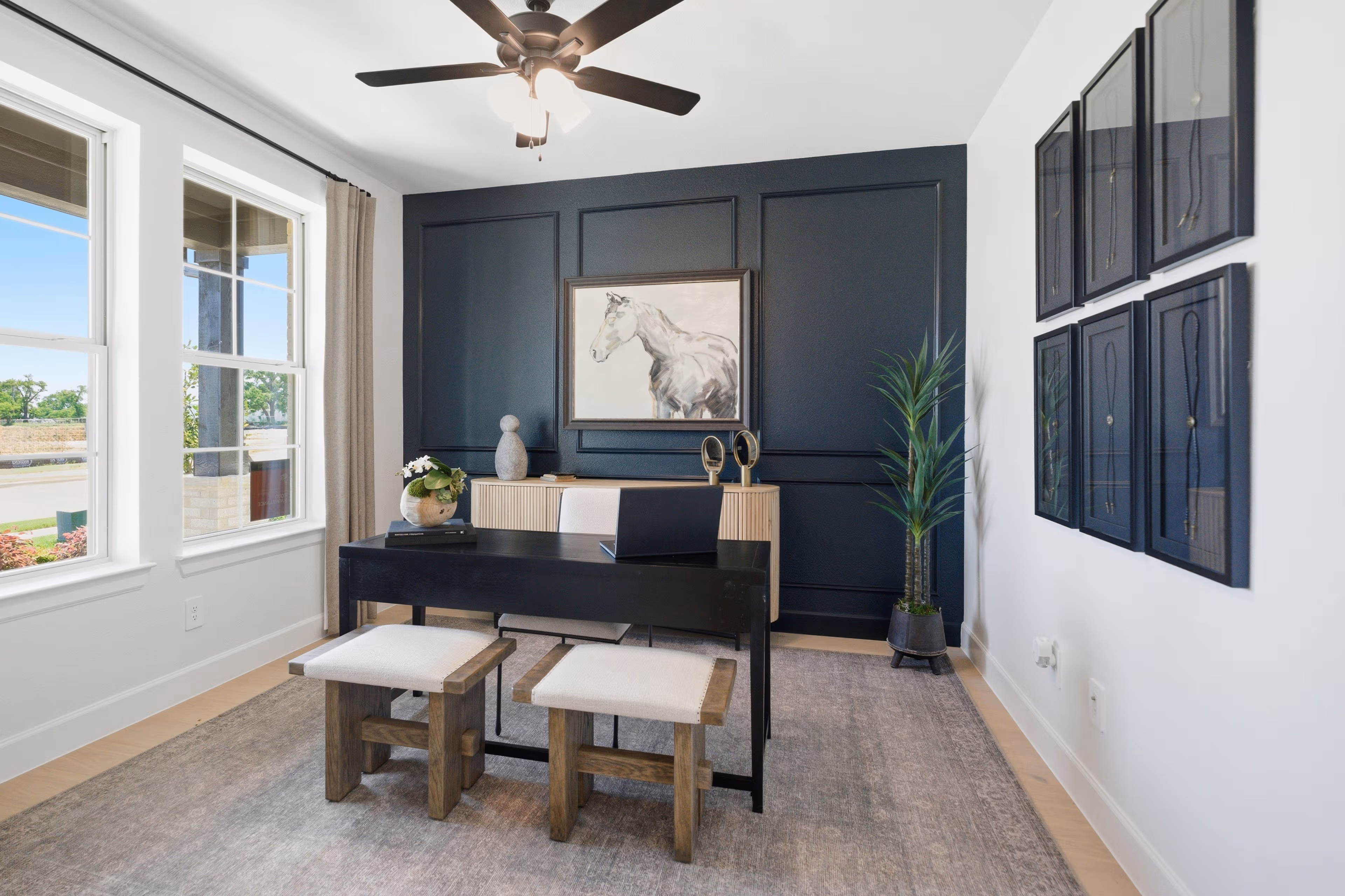 spacious study with windows and accent wall