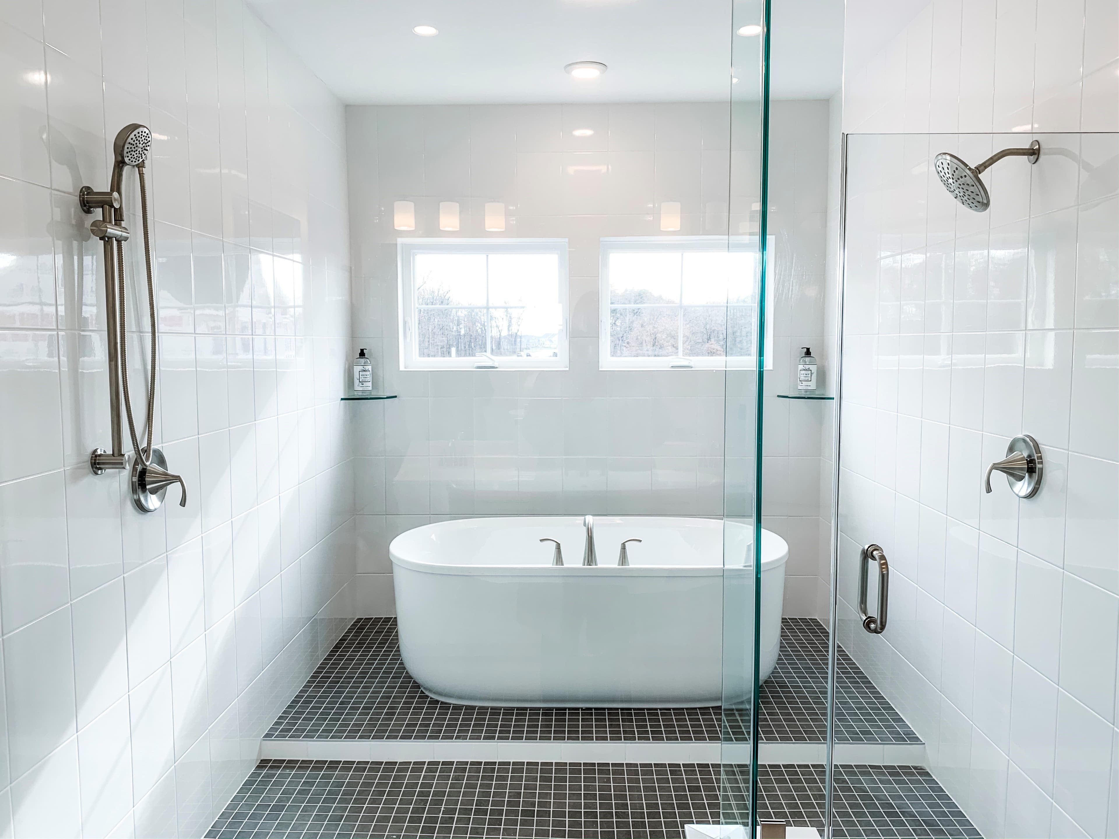 primary bathroom with a tub within a shower