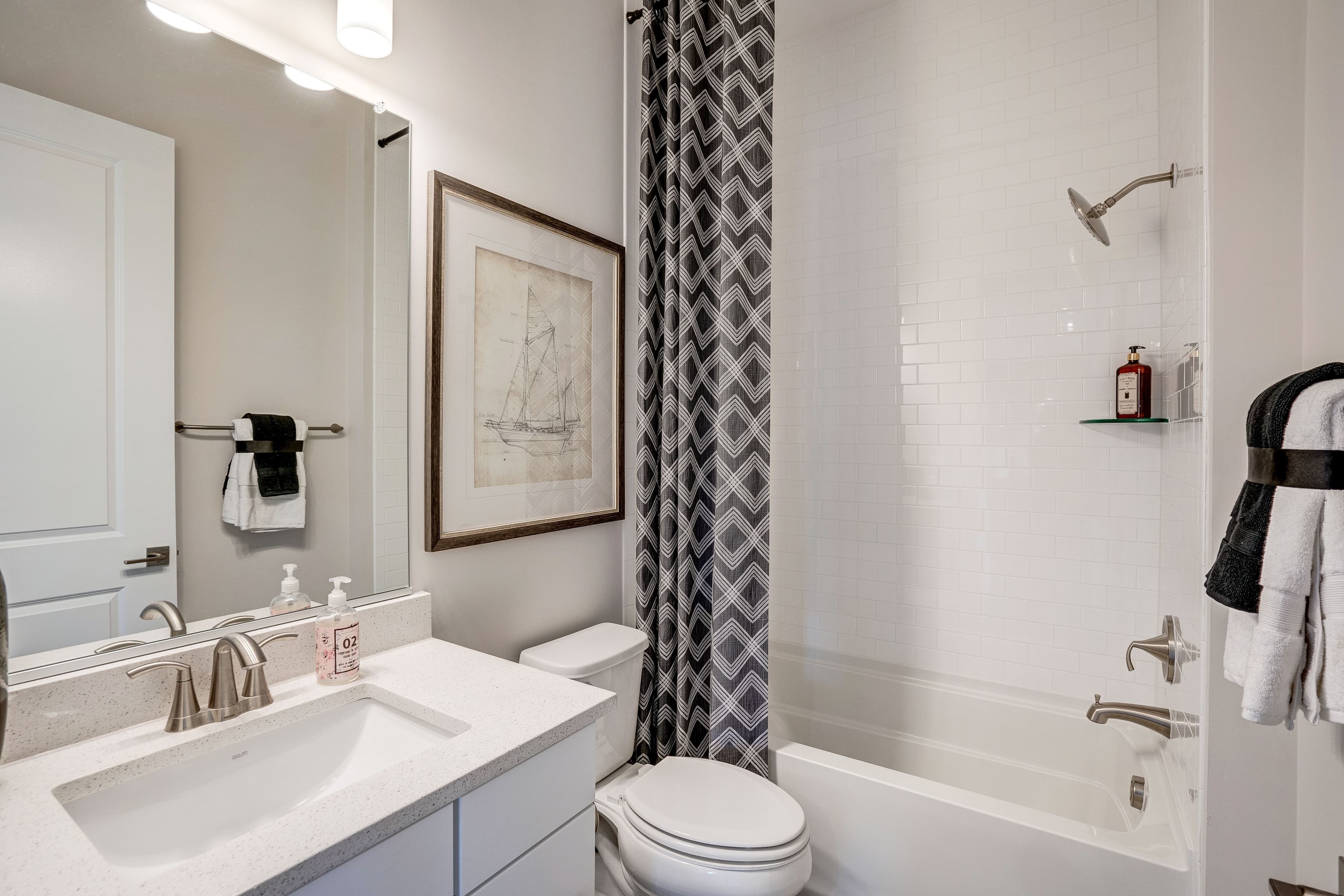 secondary bathroom with a shower and tub combo