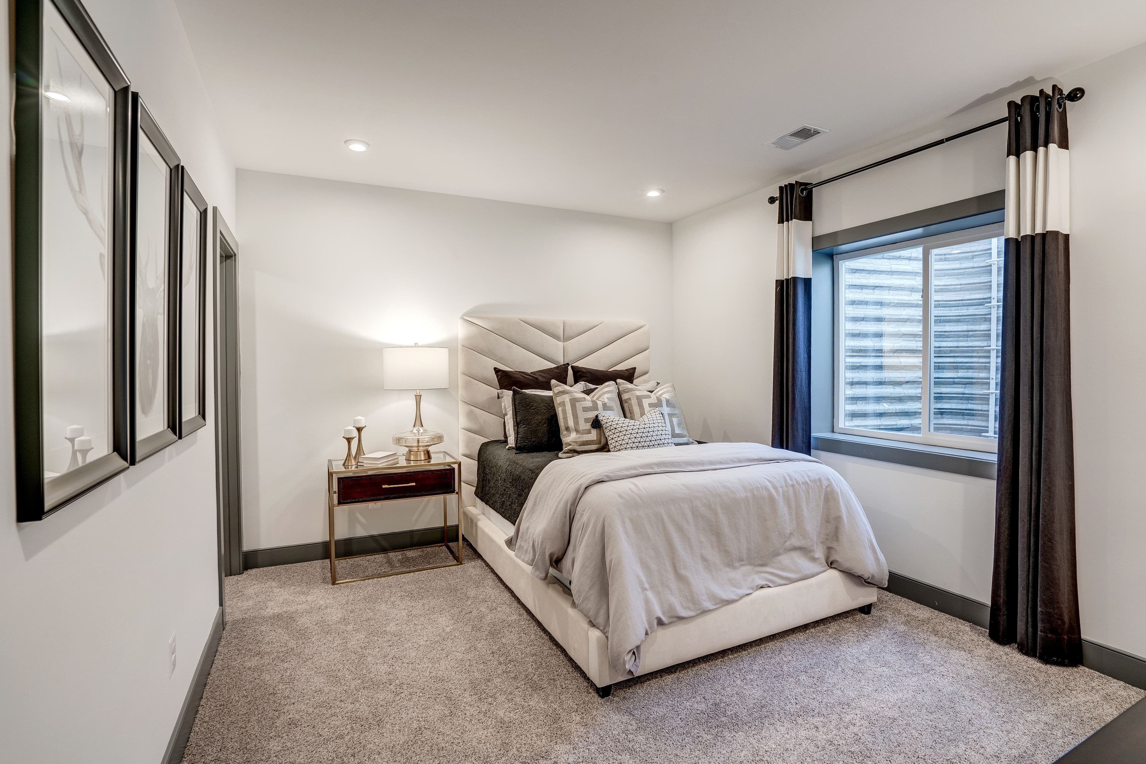 secondary bedroom with carpet and a large window
