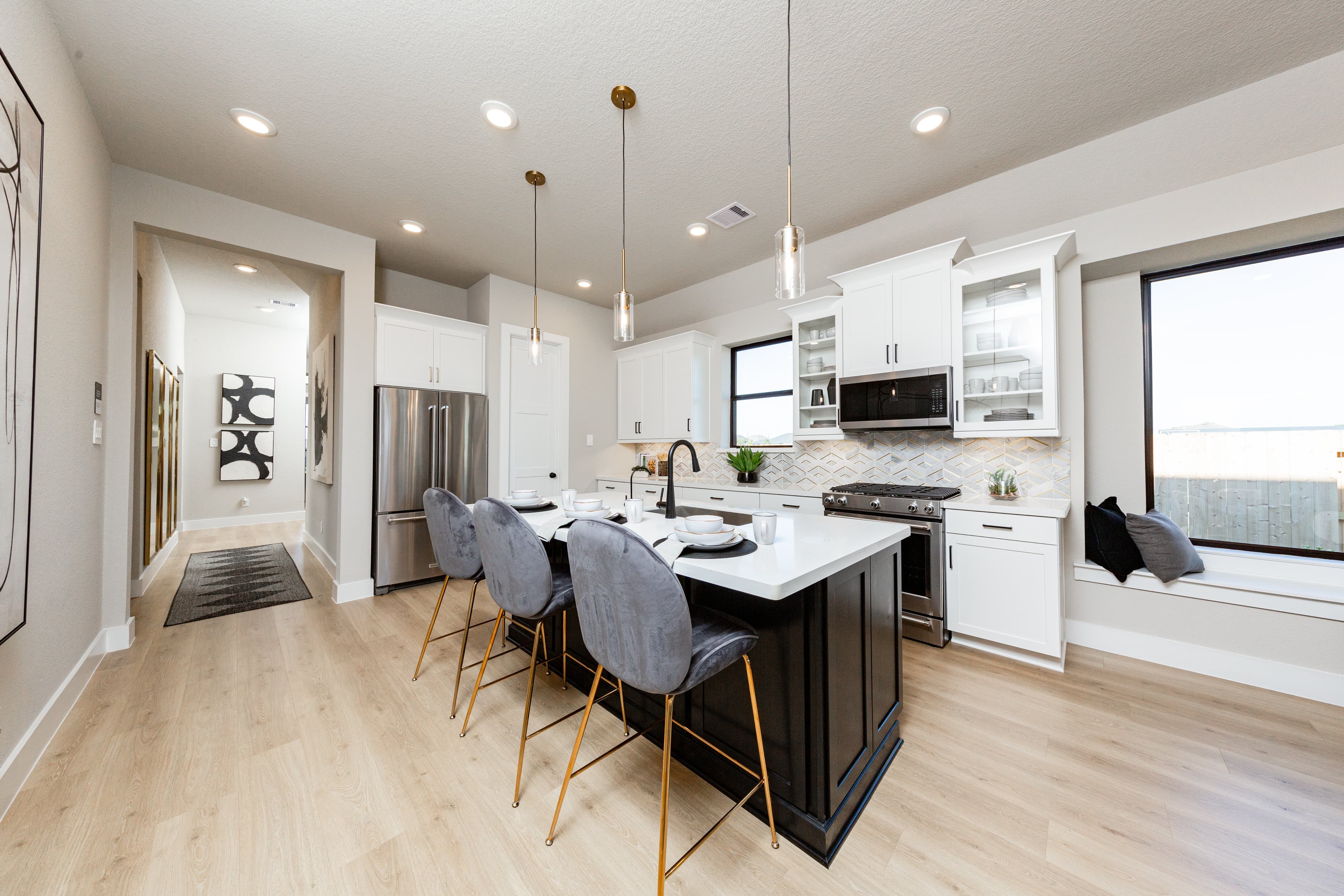 open kitchen with white cabinets and hardwood flooring