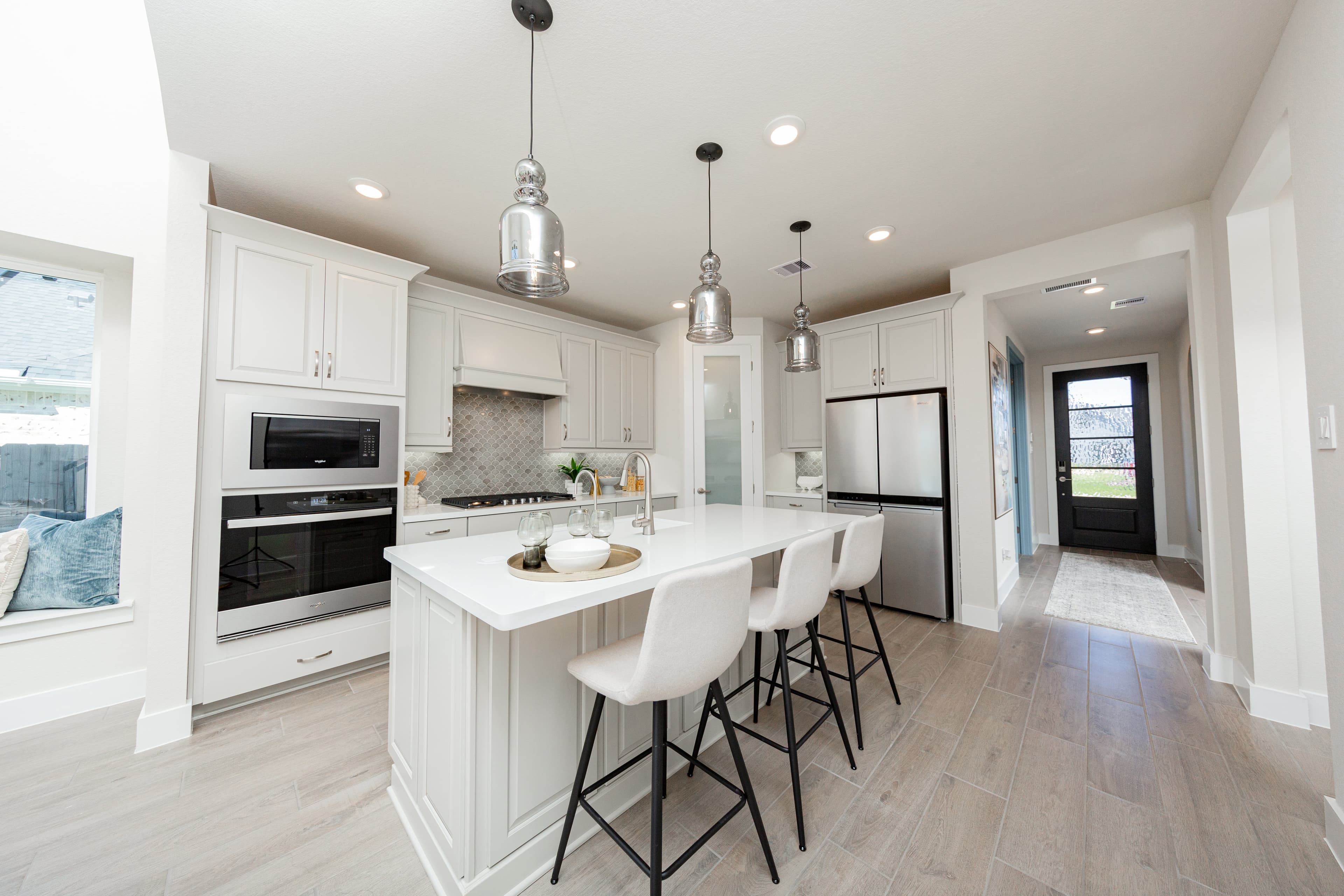 open kitchen with white cabinets and hardwood flooring