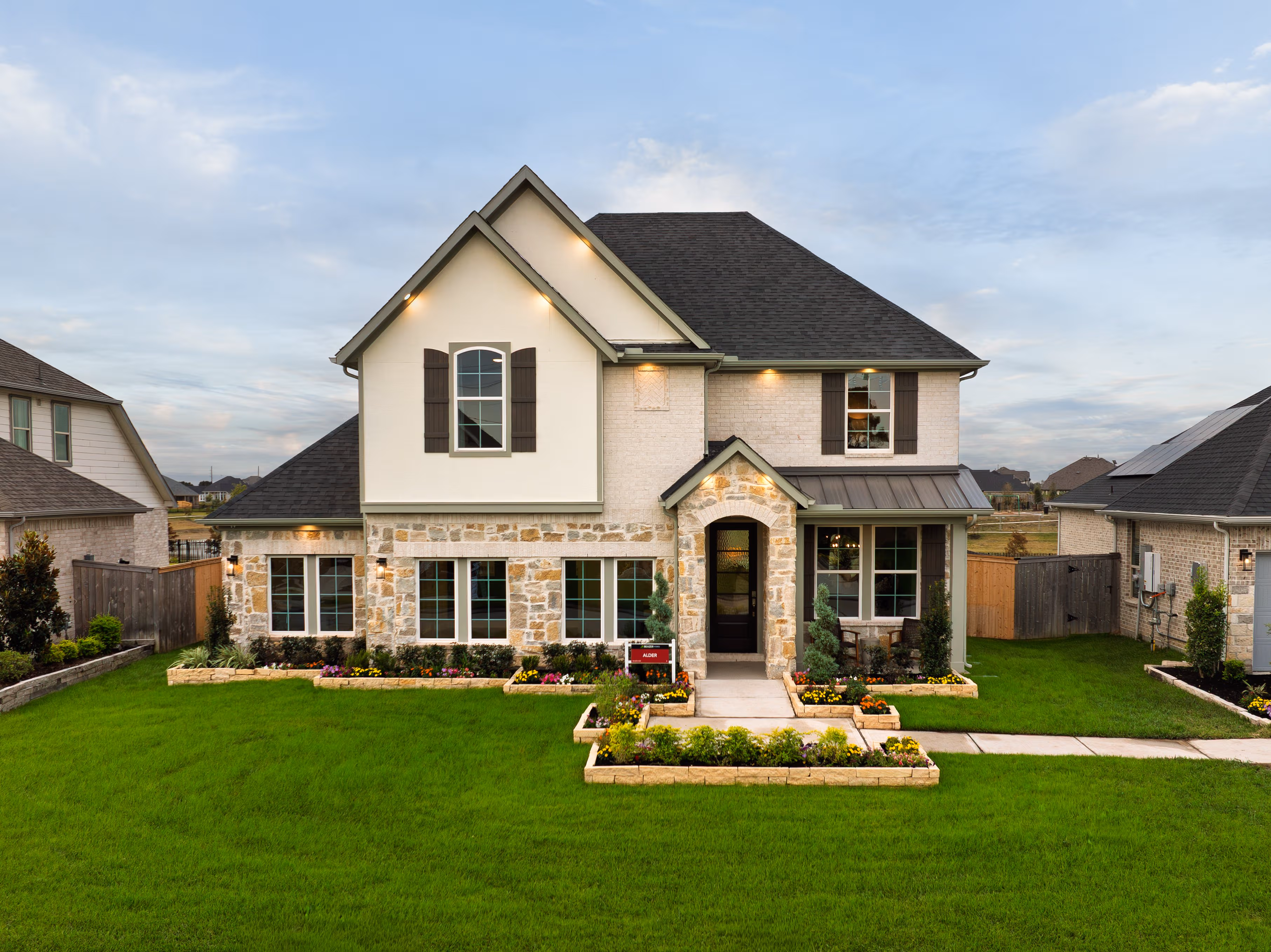 exterior of home with brown brick and white stone