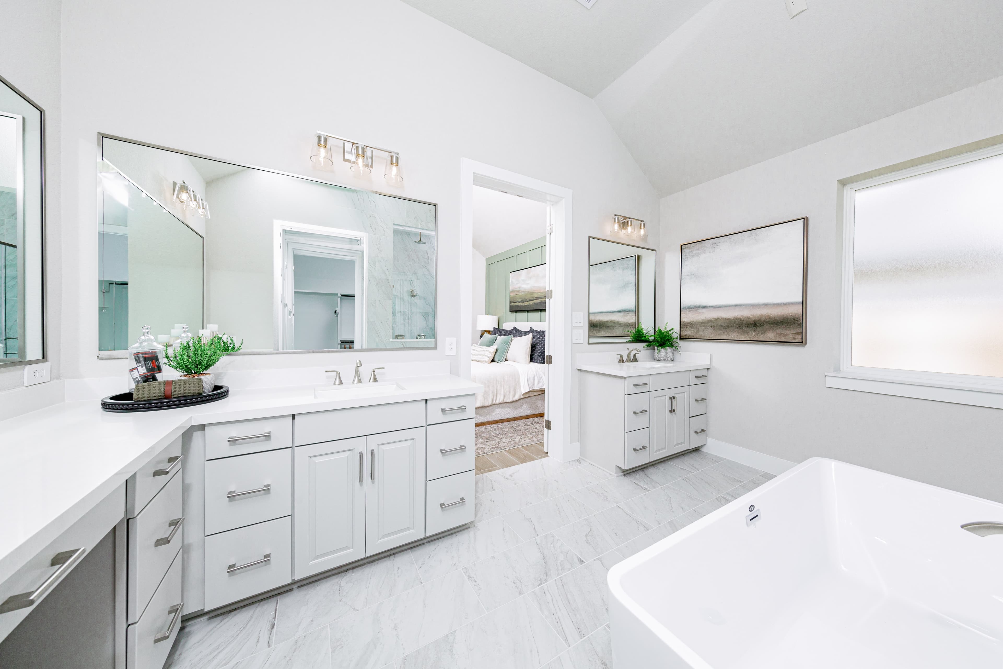 primary bathroom with tile flooring and double sinks