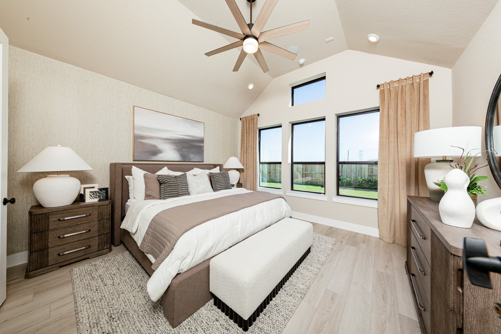 large primary bedroom with elevated ceilings and carpet