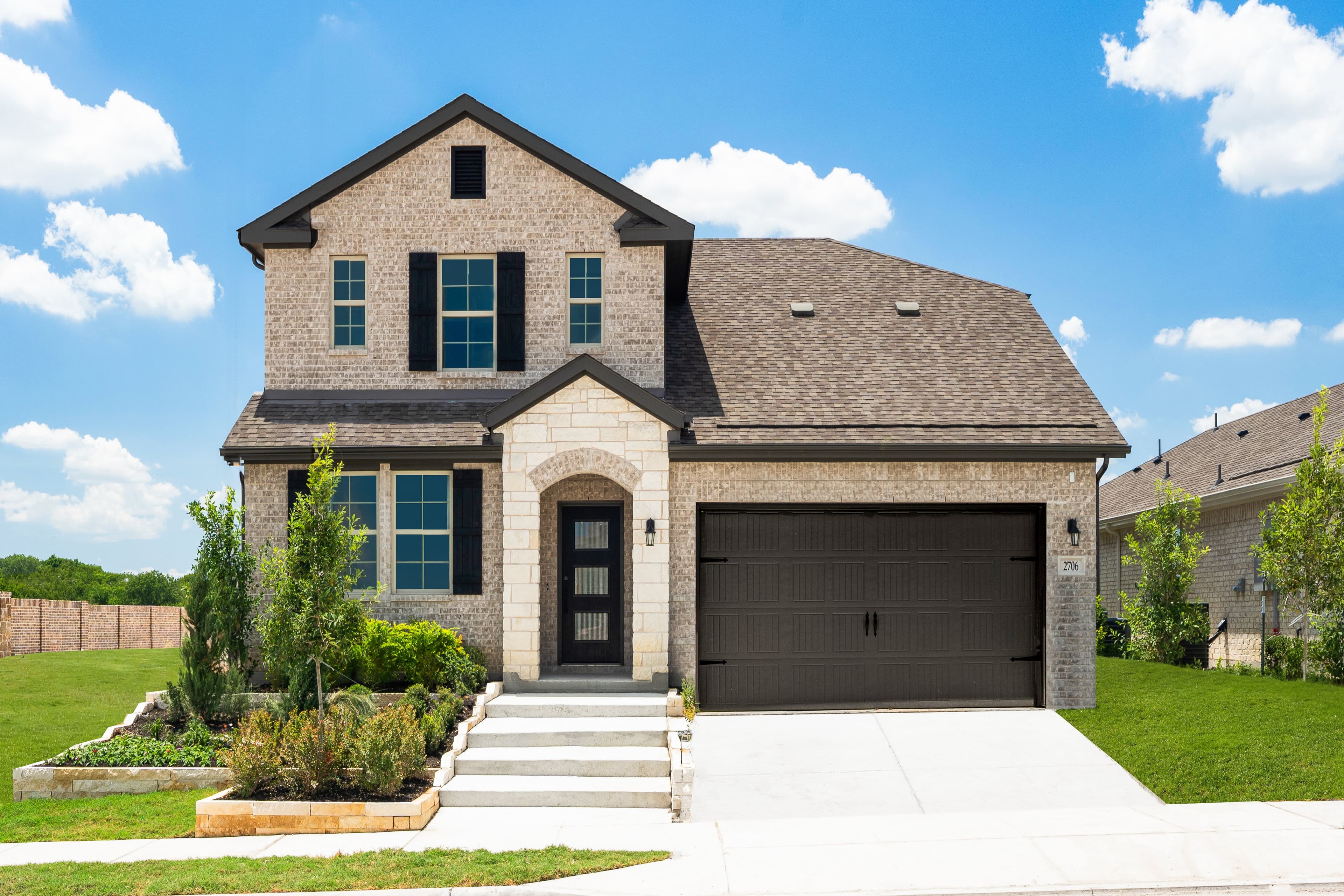 two-story home with brick and stone exterior