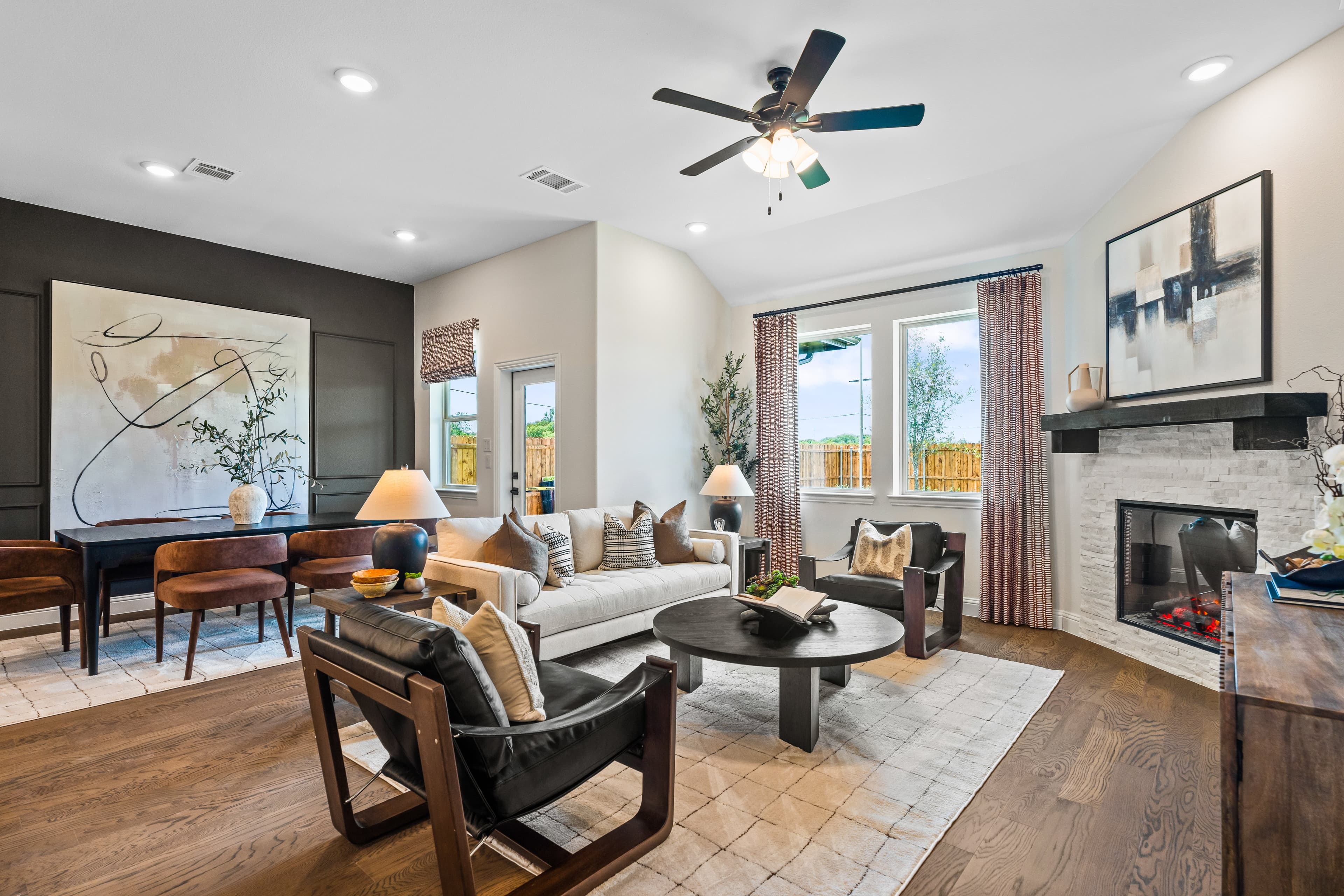open great room with wood floors and fireplace