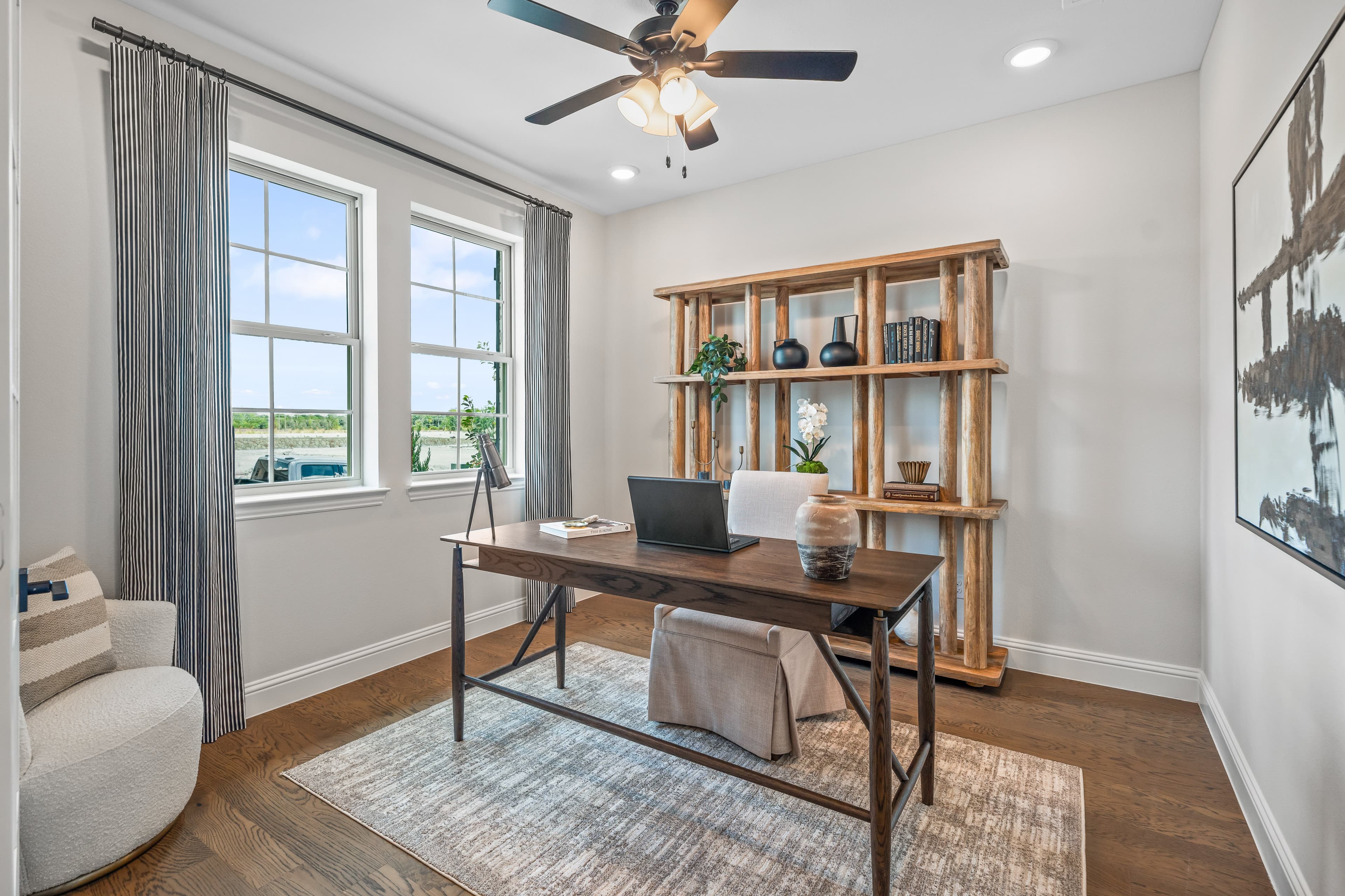 private study with wood floors and windows