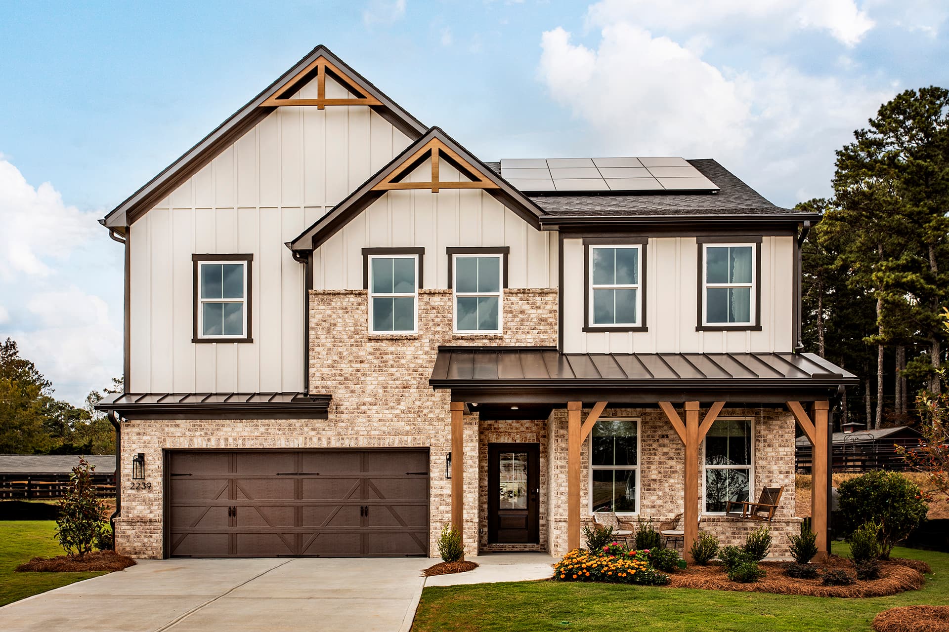 front of 2-story home with light siding and brick