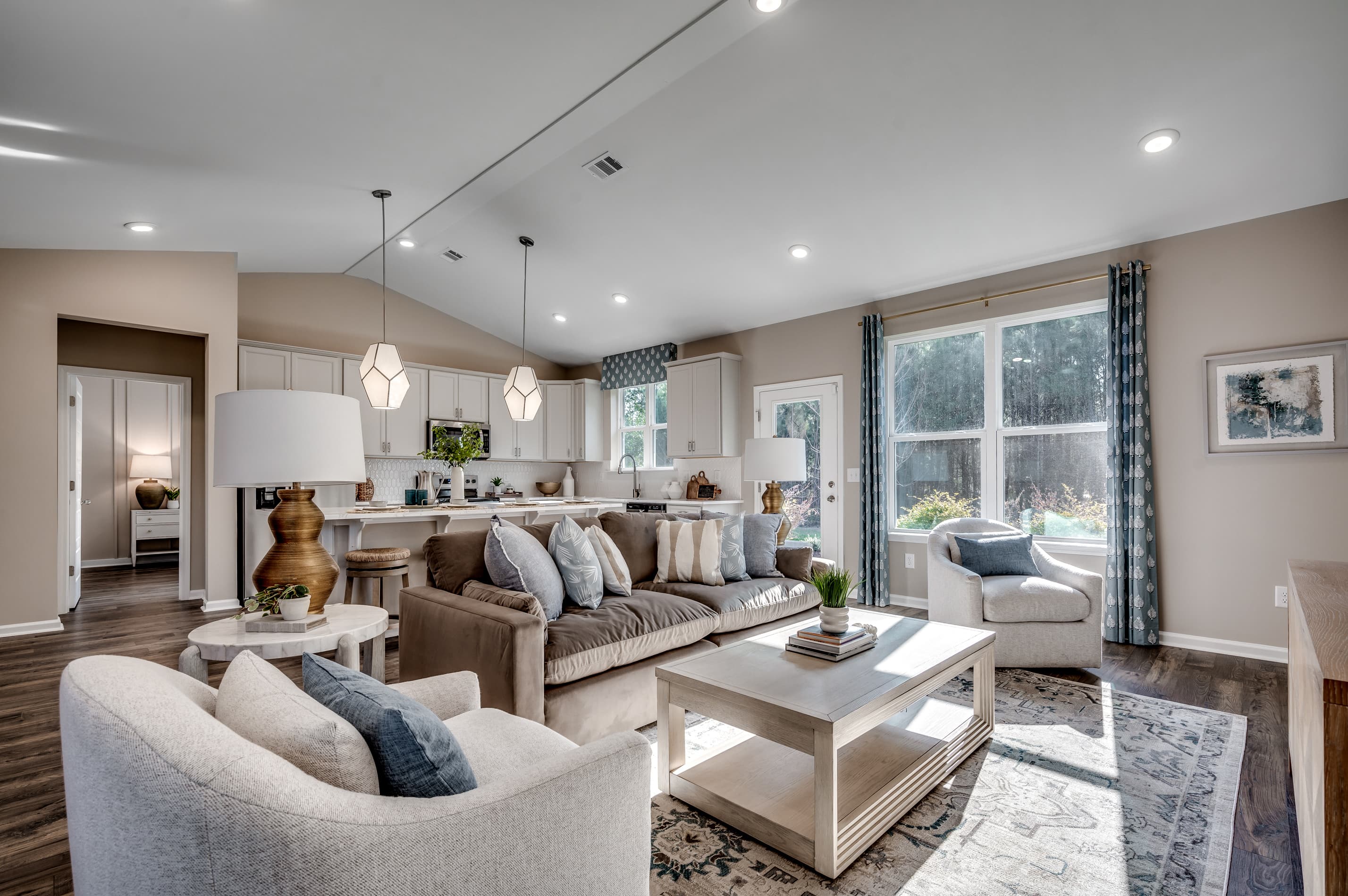 open-concept room with large couch, windows and high ceilings