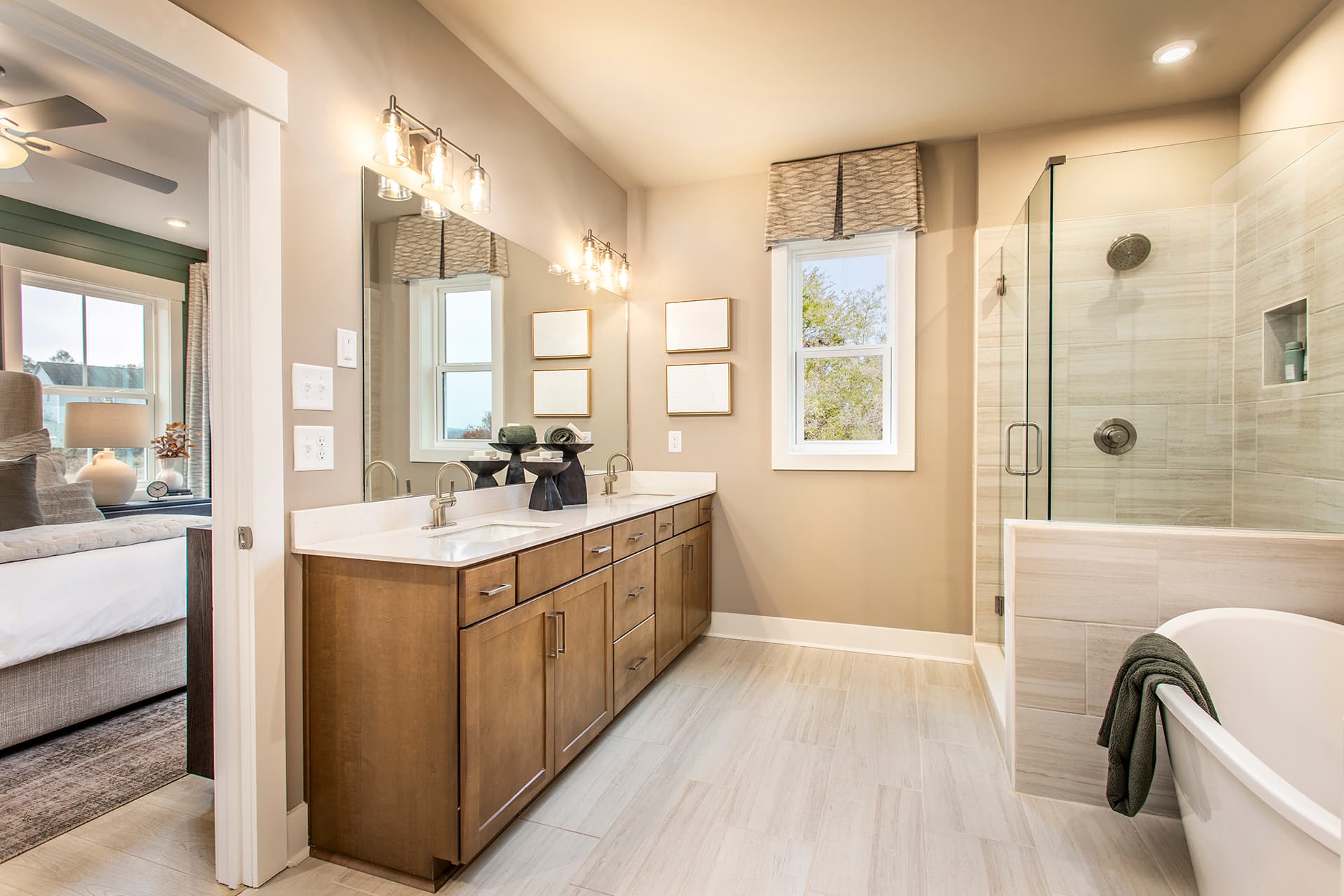 primary bathroom with wood-finish cabinets and white quartz on the vanity