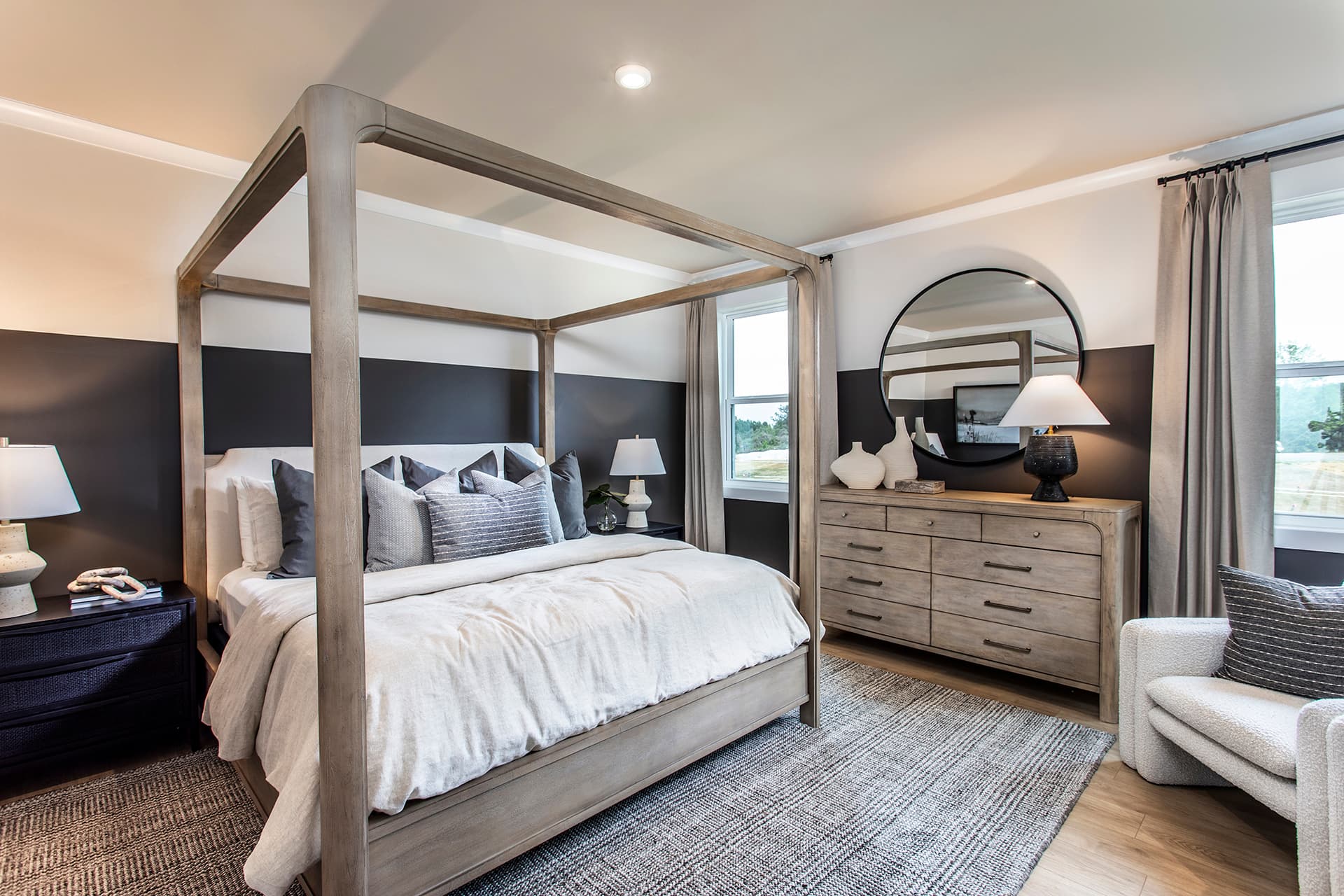 primary bedroom with windows and hard-surface flooring