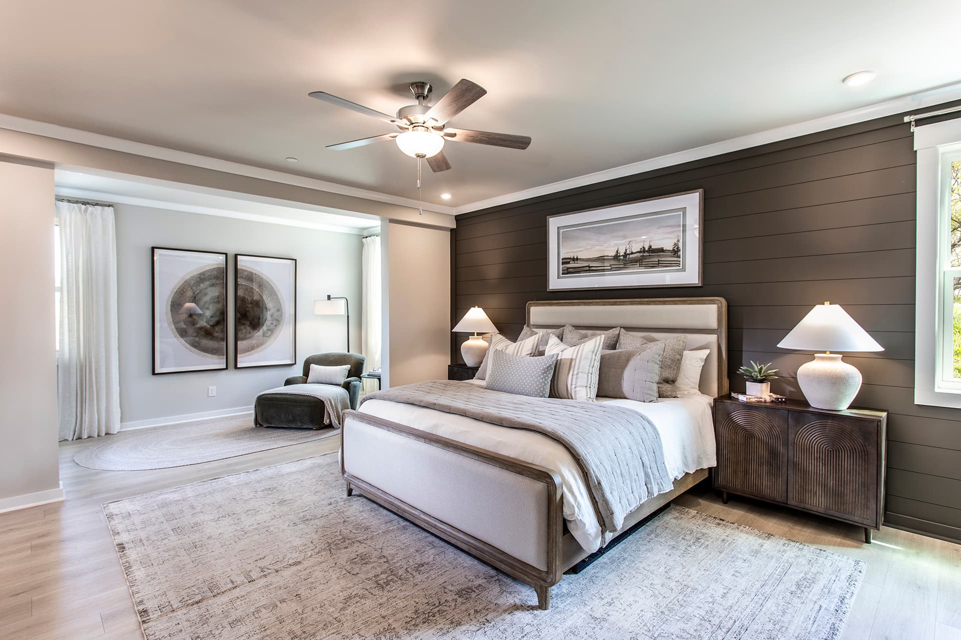 primary bedroom with hard-surface flooring and retreat room
