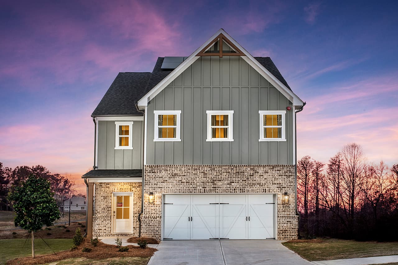 front of 3-story home with brick and gray siding