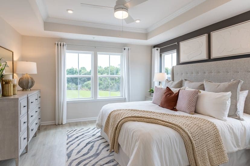 primary bedroom with large bed and dresser