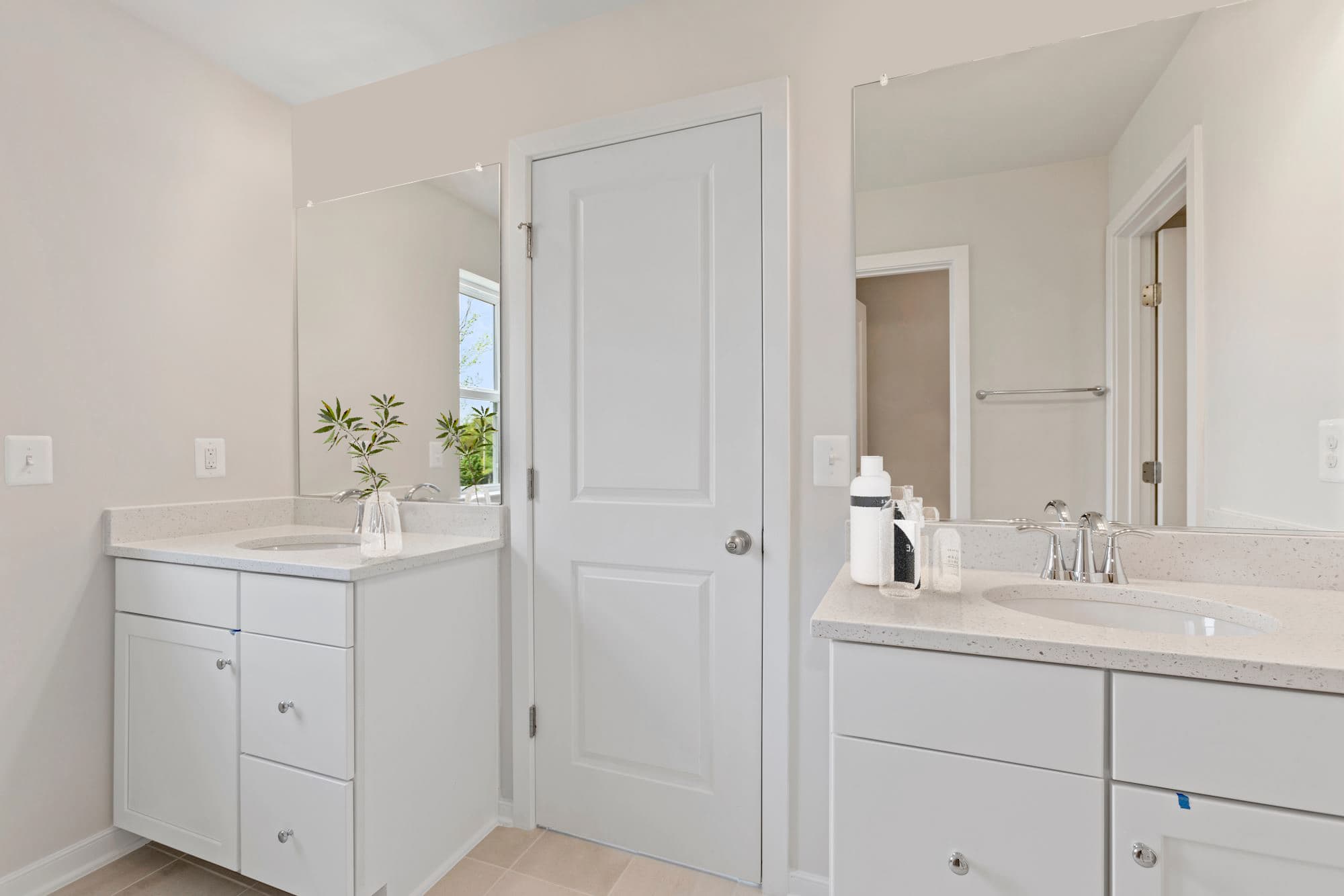 vanity sinks with white counters and 2 large mirrors