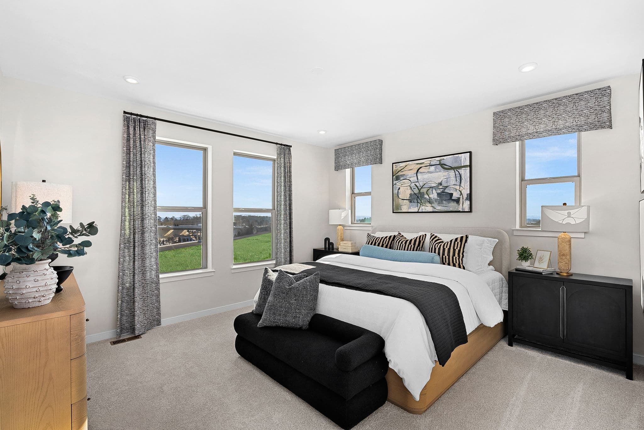 primary bedroom with carpet, large bedroom, and windows