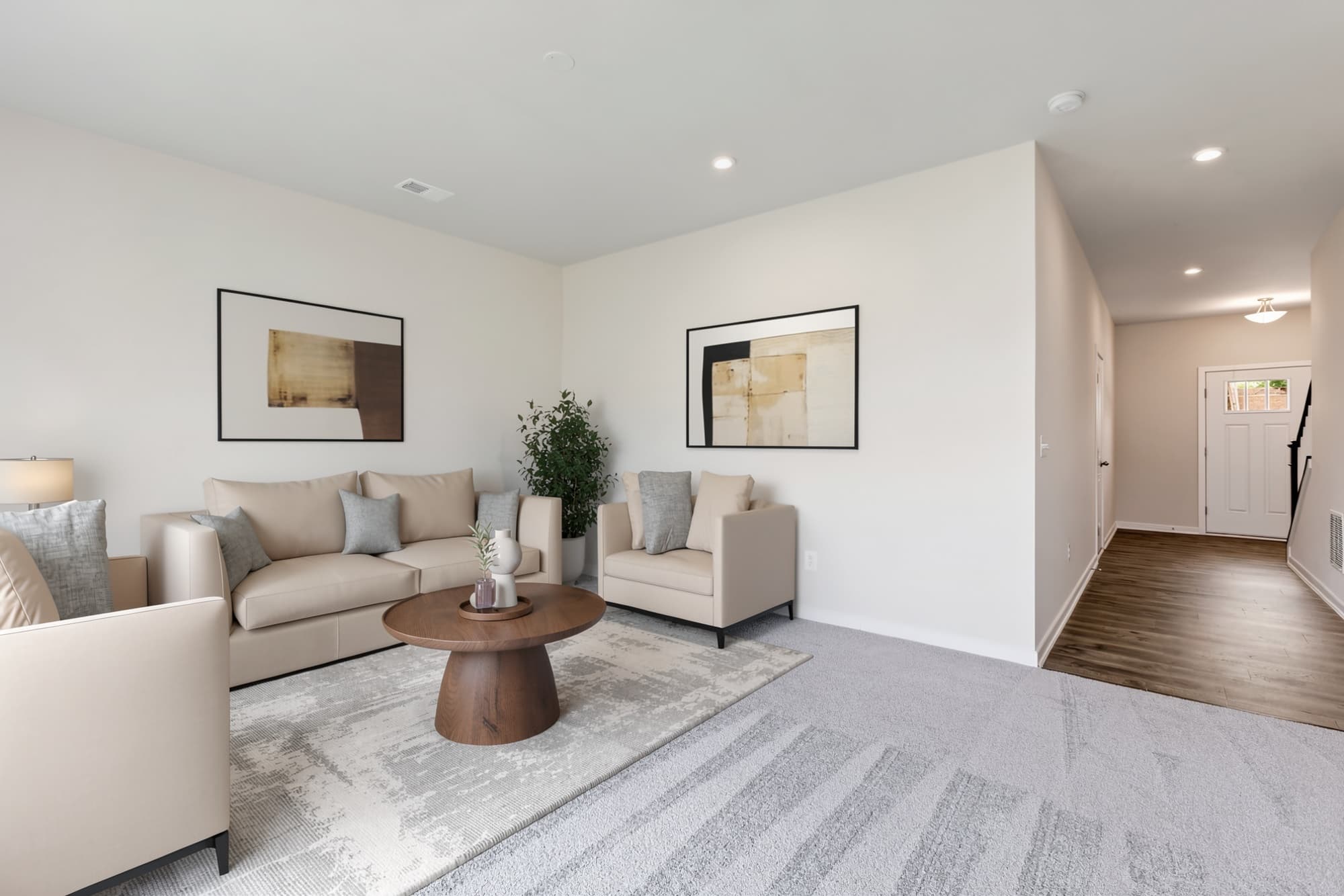 recreation room with door to outside, sectional couch and coffee table