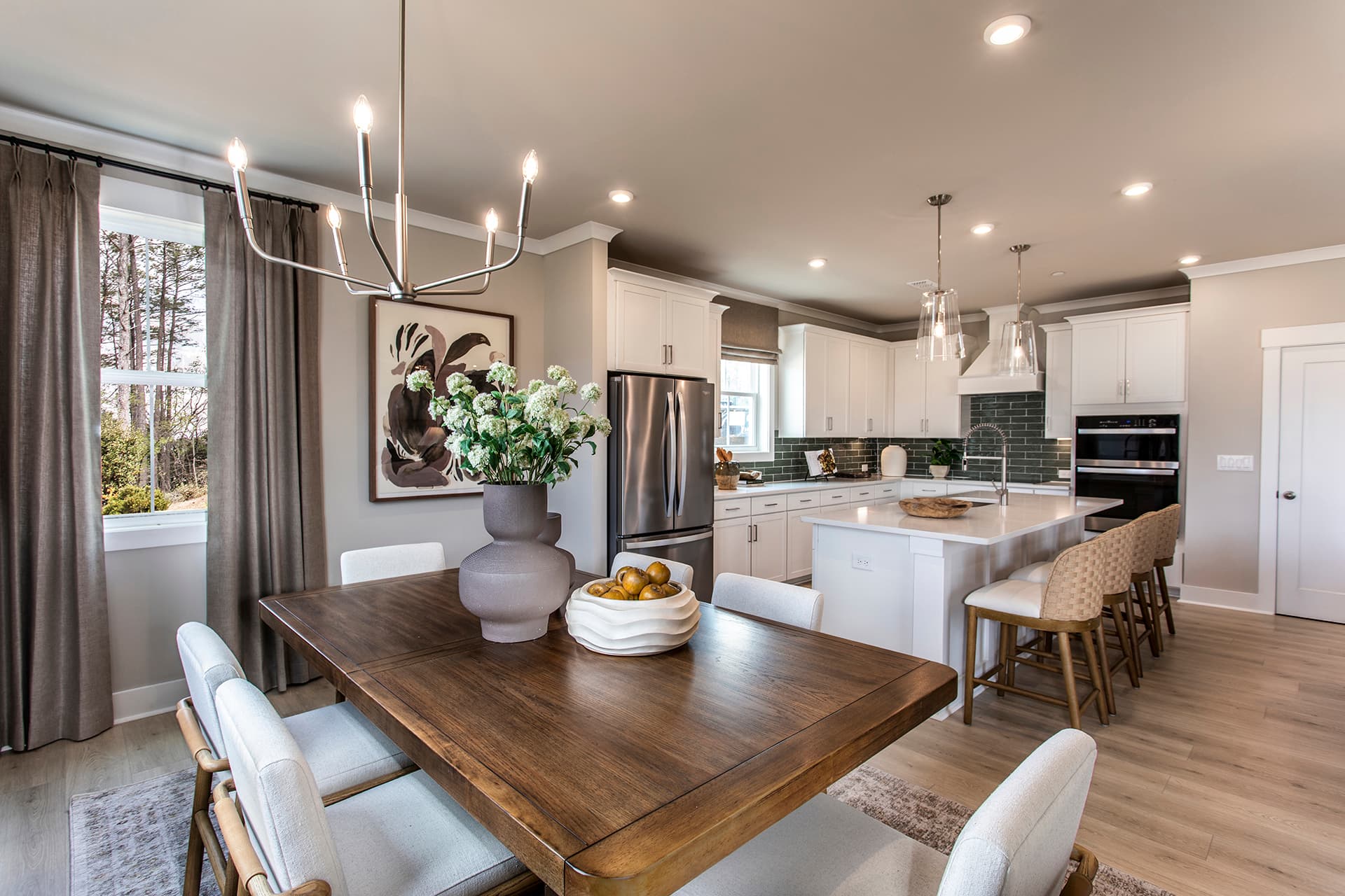 dining room with hard-surface flooring connected to kitchen