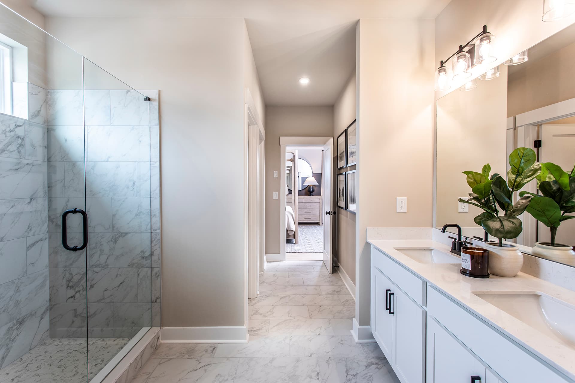 primary bathroom with white cabinets and tile flooring