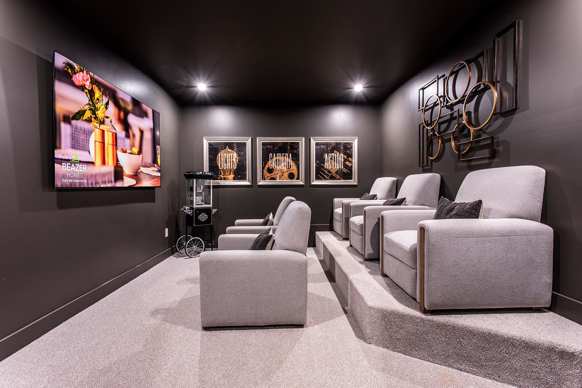 media room in basement with seating and oversized tv