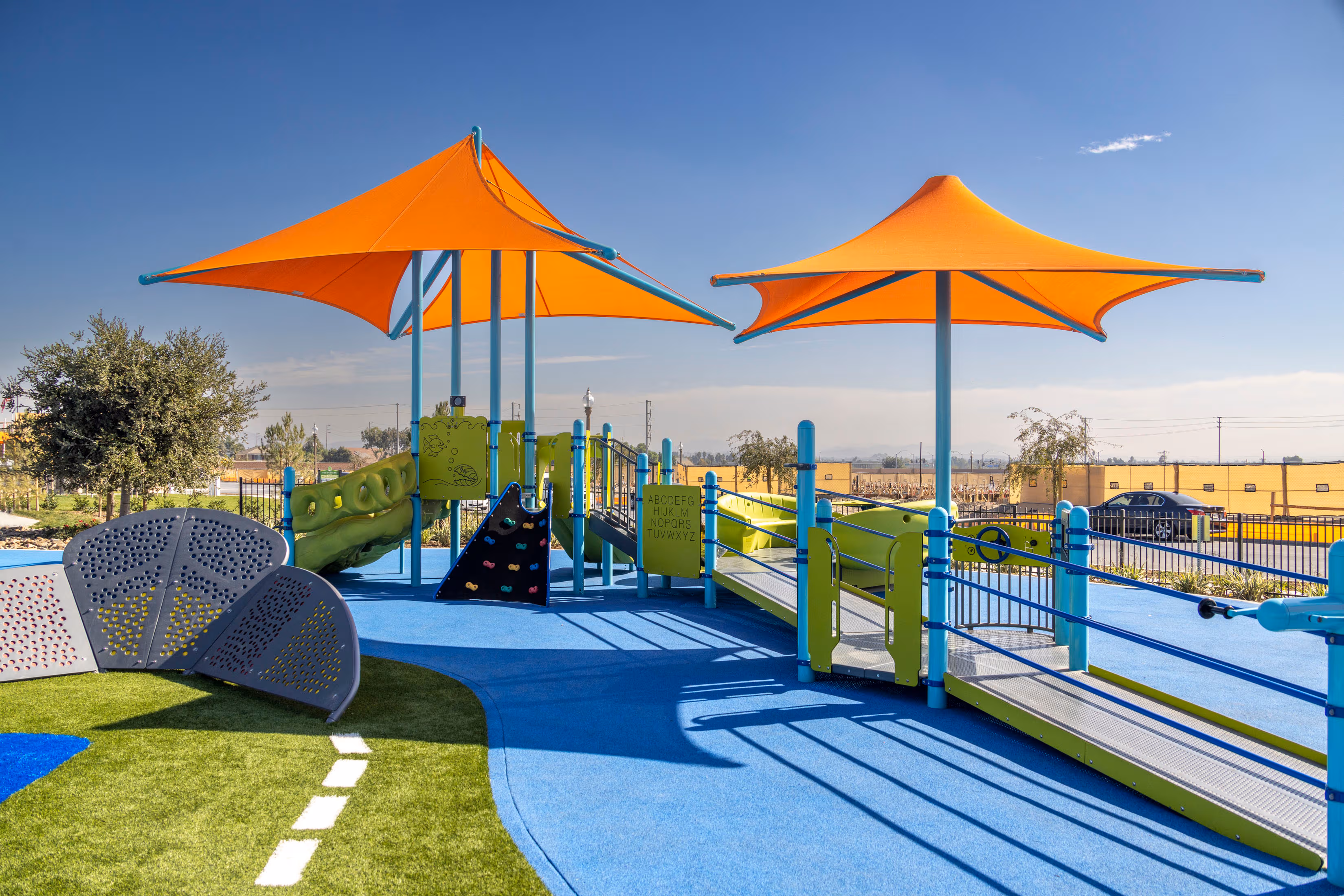 outdoor playground with slide and climbing wall