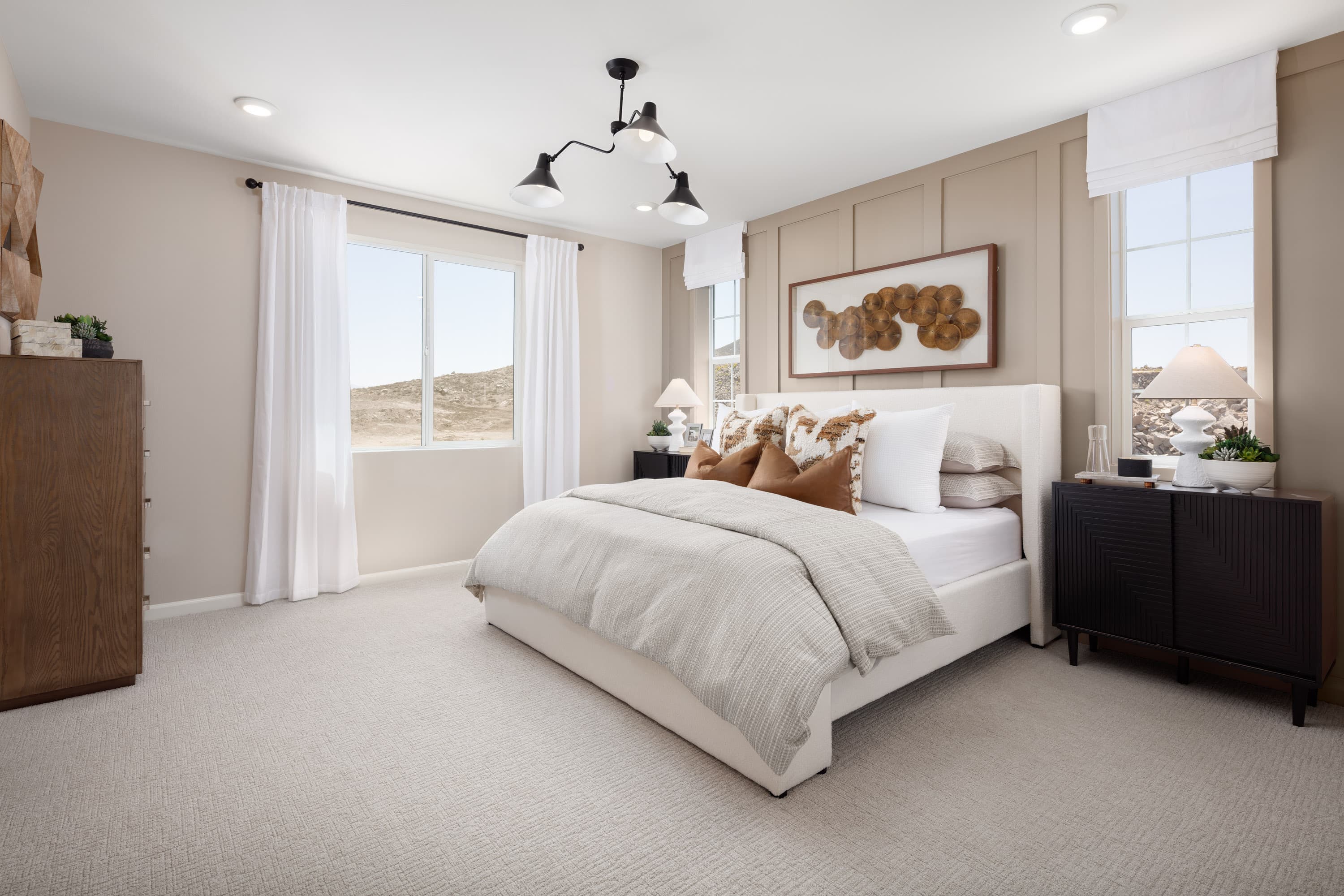 primary bedroom with neutral floors and large windows