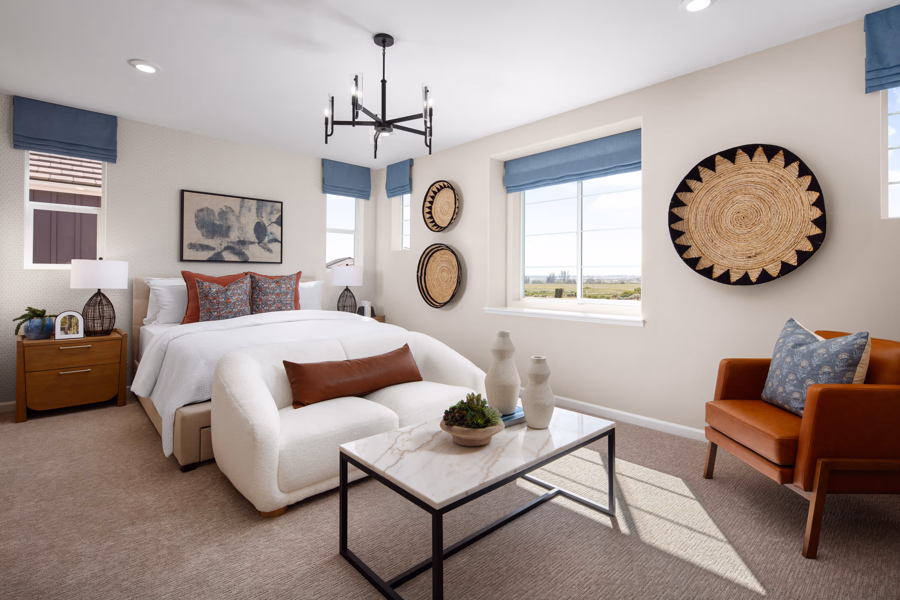 primary bedroom with neutral carpet and large windows